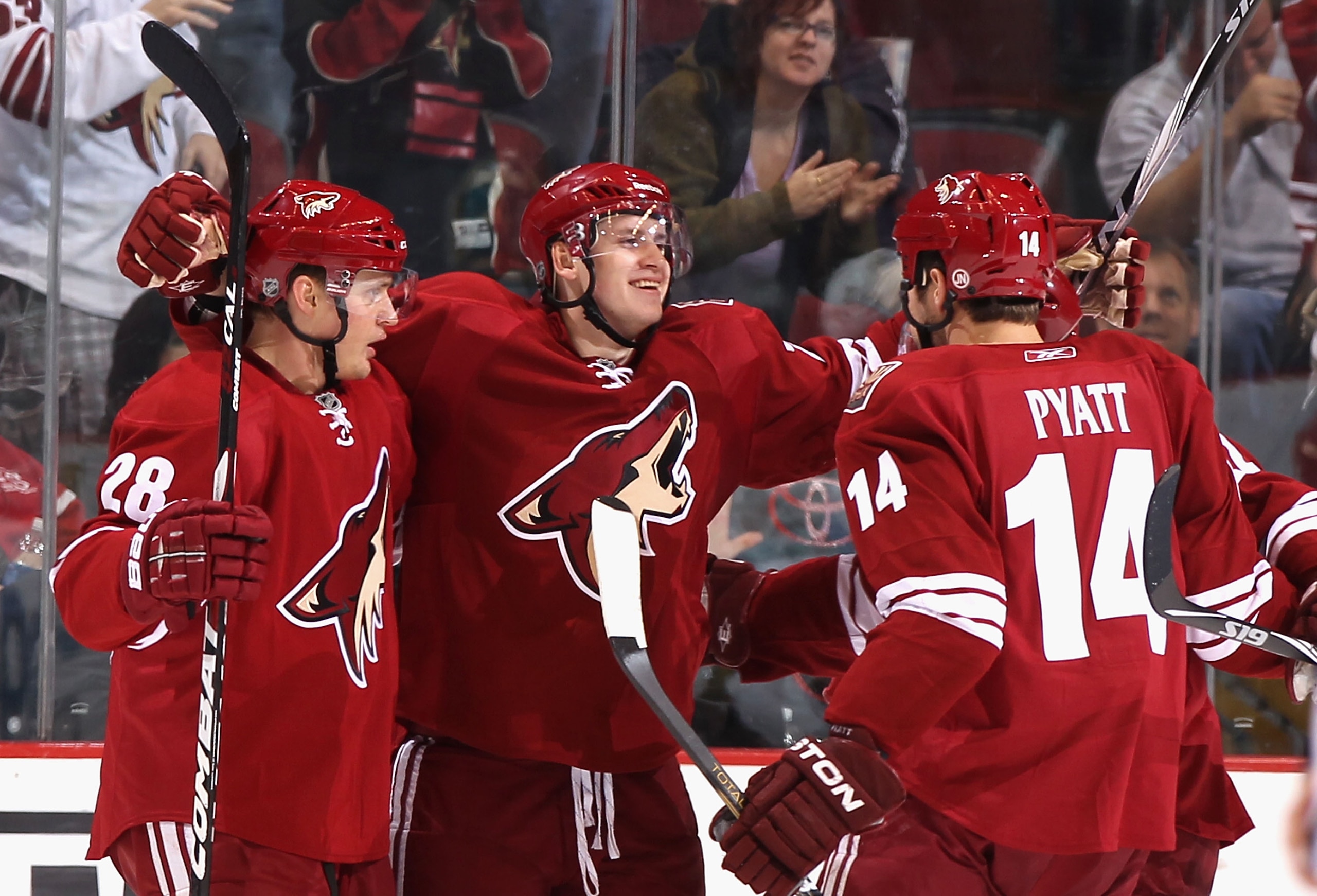 GLENDALE, AZ - JANUARY 17:  Oliver Ekman-Larsson #23 of the Phoenix Coyotes celebrates with teammates Lauri Korpikoski #28 and Taylor Pyatt #14 after Ekman-Larsson scored his first career goal against the San Jose Sharks during the third period of the NHL
