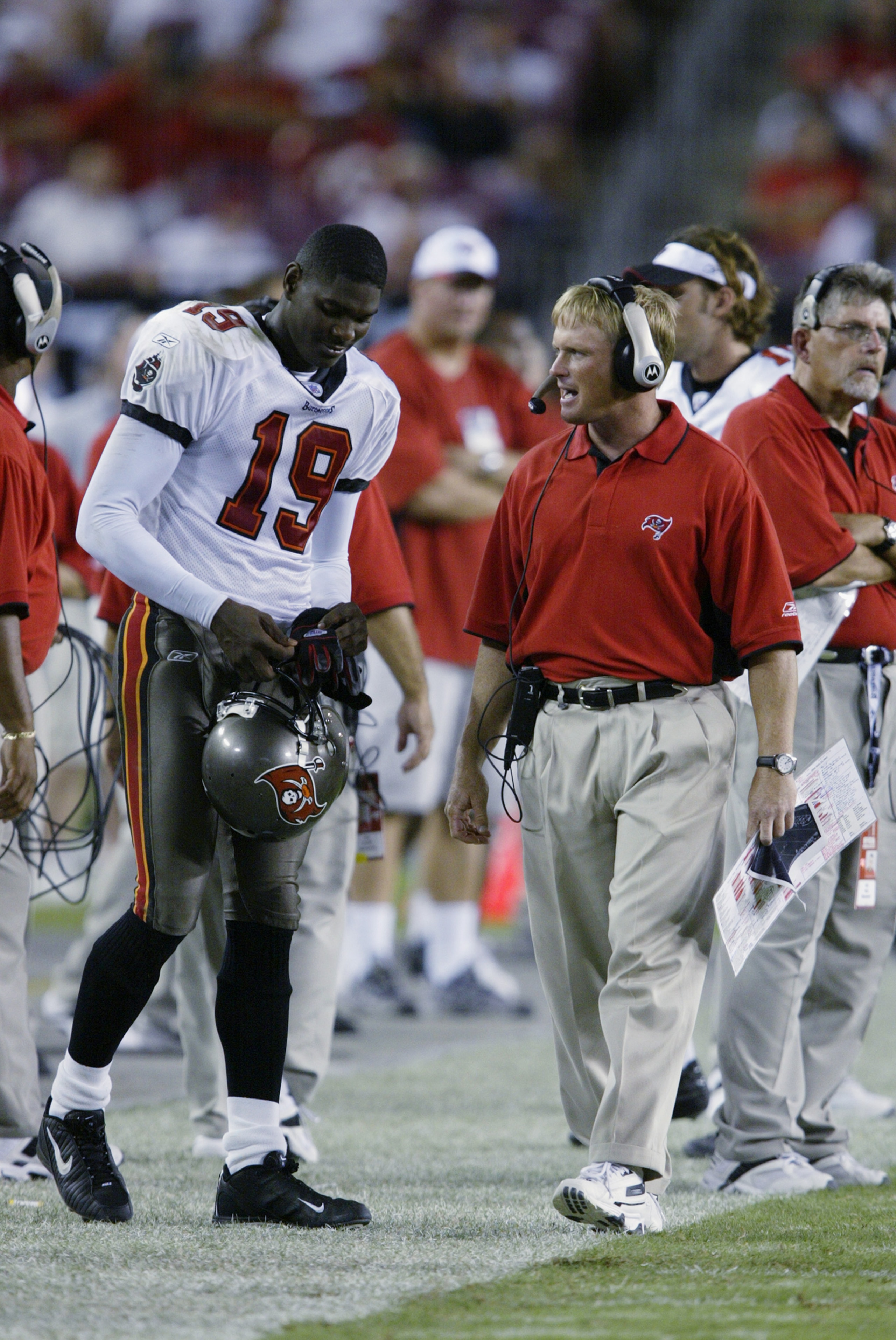 TAMPA, FL - SEPTEMBER 23:  Head coach Jon Gruden of the Tampa Bay Buccaneers talks to wide receiver Keyshawn Johnson #19 during the NFL game against the St. Louis Rams on September 23, 2002 at Raymond James Stadium in Tampa, Florida. The Buccaneers won 26
