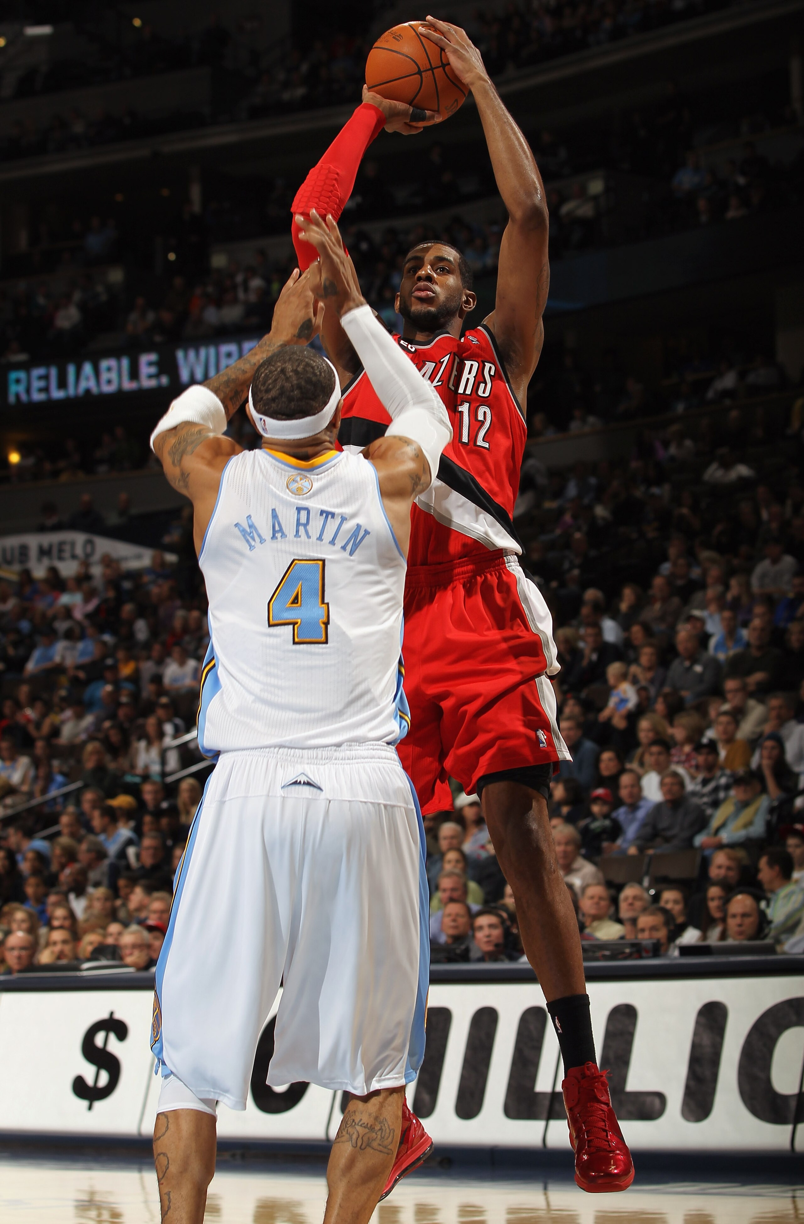 DENVER - DECEMBER 28:  LaMarcus Aldridge #12 of the Portland Trail Blazers takes a shot over Kenyon Martin #4 of the Denver Nuggets at Pepsi Center on December 28, 2010 in Denver, Colorado. The Nuggets defeated the Blazers 95-77. NOTE TO USER: User expres