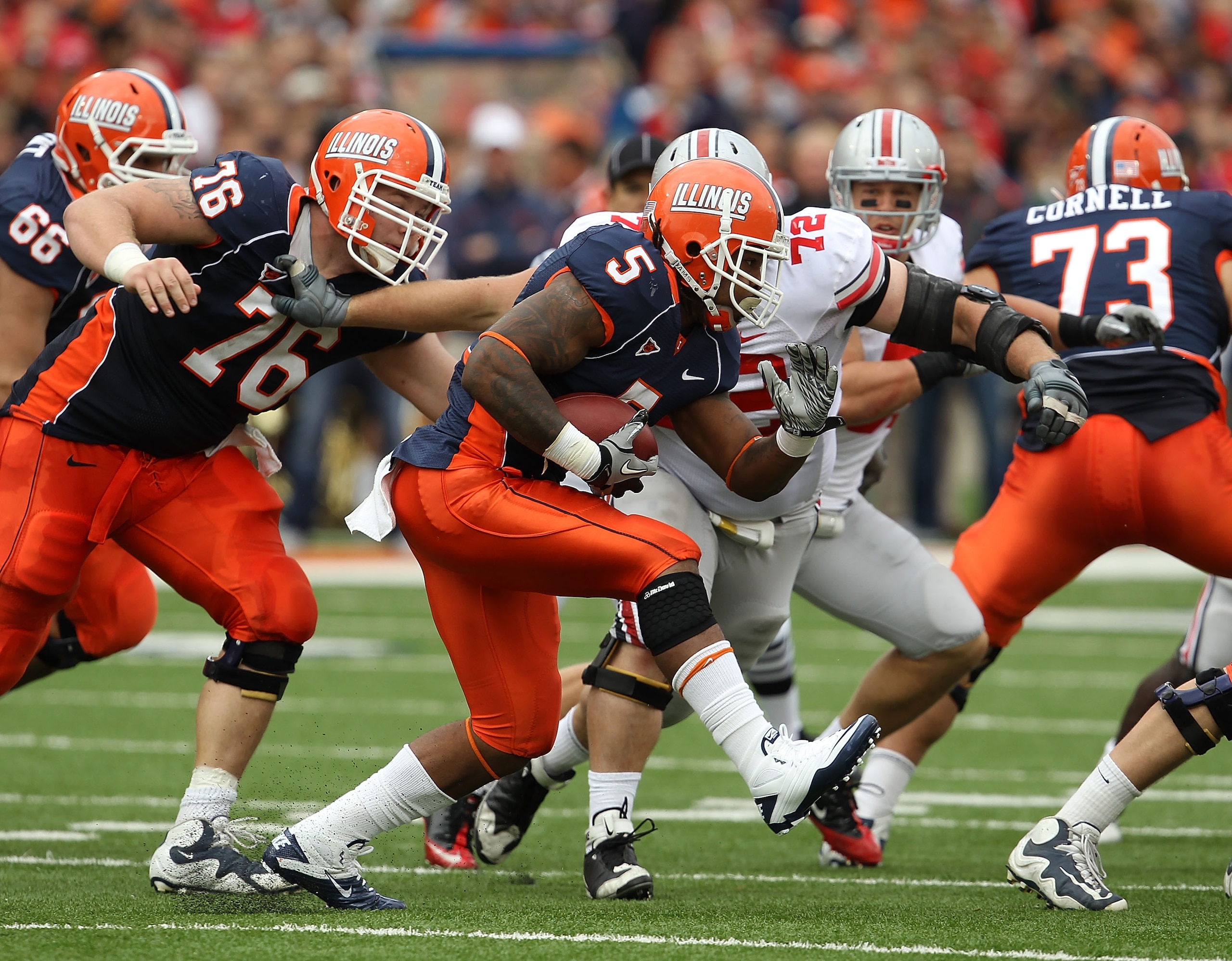 CHAMPAIGN, IL - OCTOBER 02: Mikel Leshoure #5 of the Illinois Fighting Illini runs as teammate Graham Pocic #76 tries to hold off Dexter Larimore #72 of the Ohio State Buckeyes at Memorial Stadium on October 2, 2010 in Champaign, Illinois. Ohio State defe