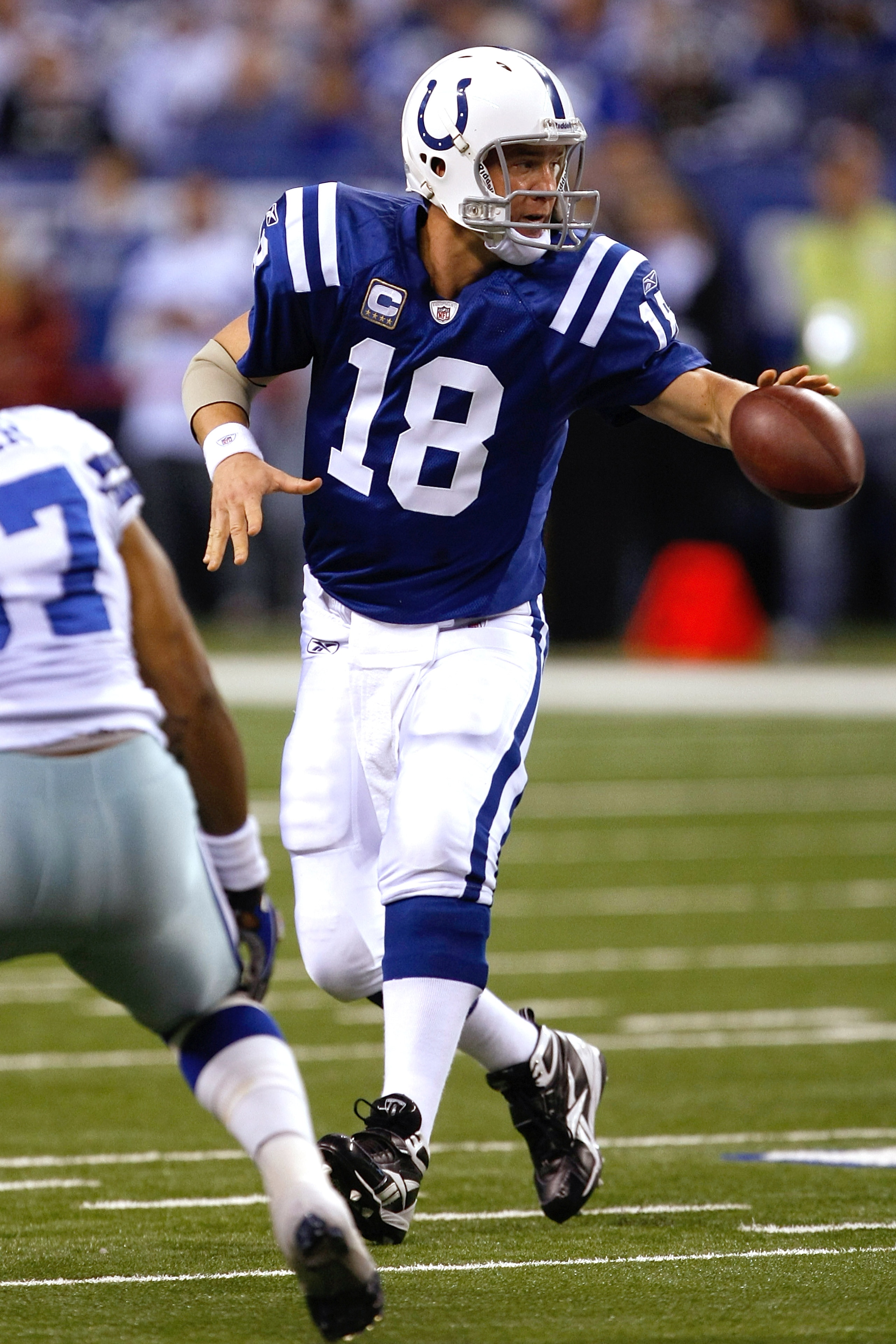 INDIANAPOLIS, IN - DECEMBER 05: Peyton Manning #18 of the Indianapolis Colts pitches the football against the Dallas Cowboys at Lucas Oil Stadium on December 5, 2010 in Indianapolis, Indiana. The Cowboys defeated the Colts 38-35 in overtime. (Photo by Sco