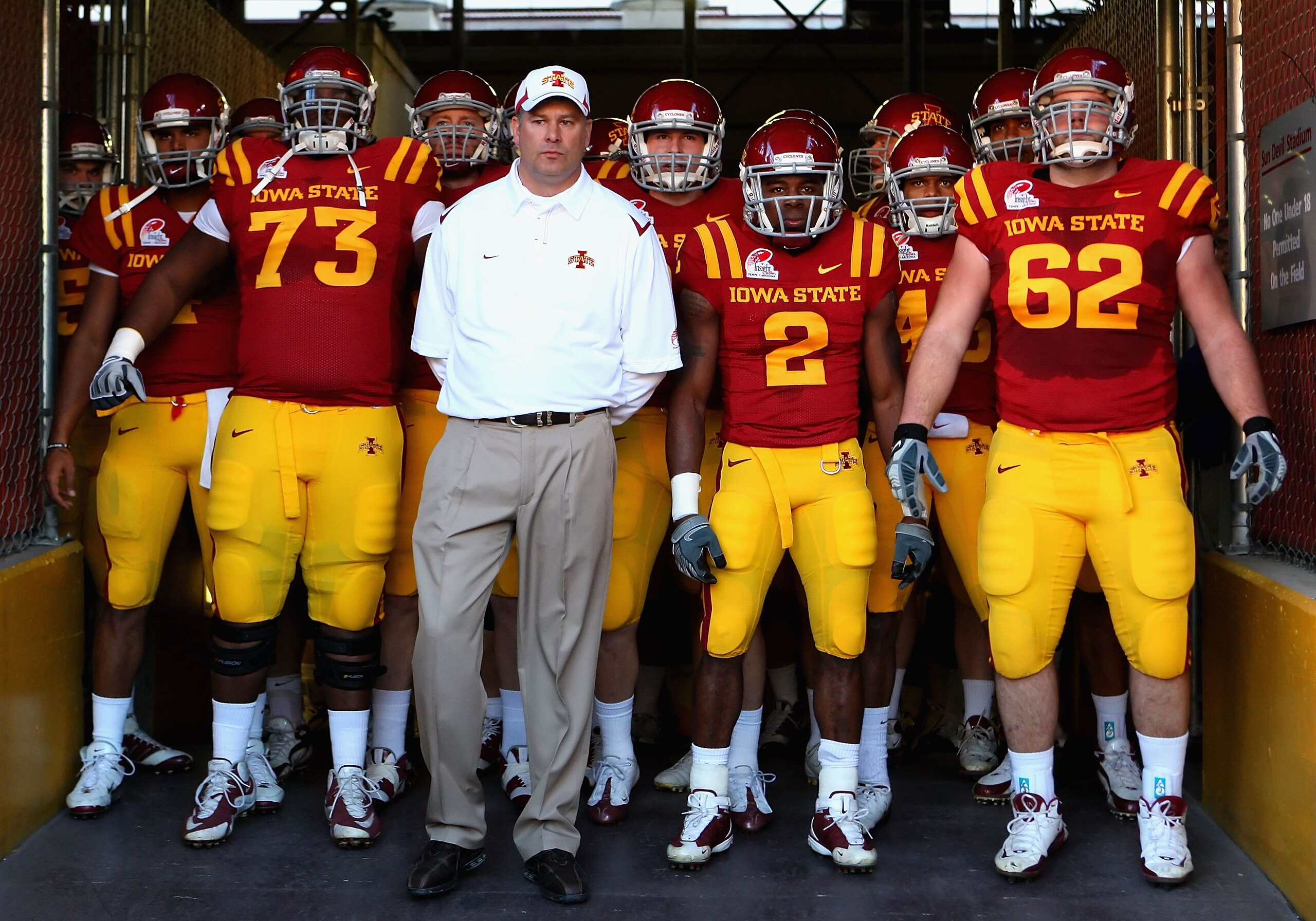 TEMPE, AZ - DECEMBER 31:  (L-R) Reggie Stephens #73, head coach Paul Rhoads, Sedrick Johnson #2 and Nate Frere #62 of the Iowa State Cyclones stand with teammates as they prepare to take the field before the Insight Bowl against the Minnesota Golden Gophe