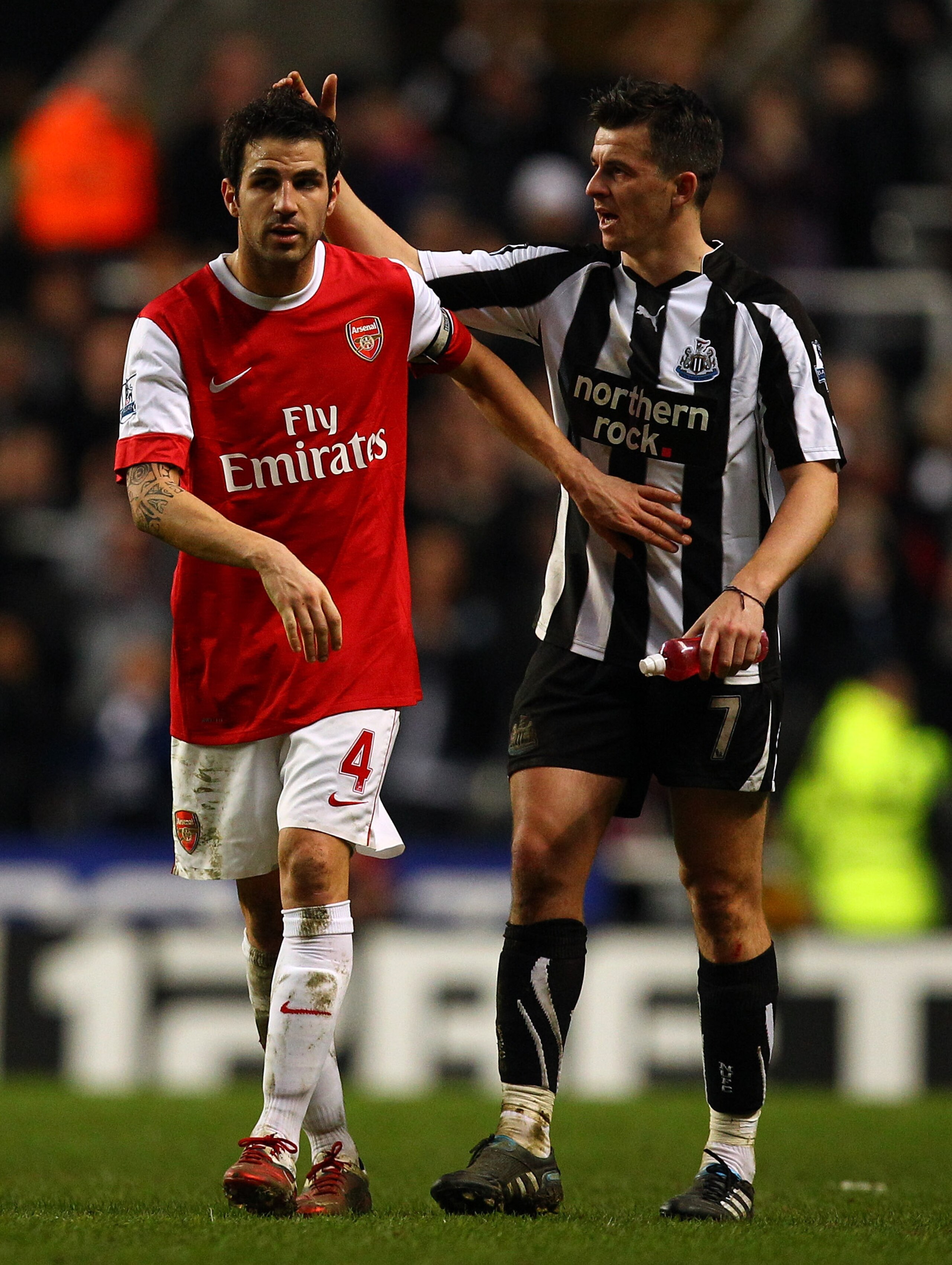NEWCASTLE UPON TYNE, ENGLAND - FEBRUARY 05:  Cesc Fabregas of Arsenal and Joey Barton of Newcastle at the final whistle during the Barclays Premier League match between Newcastle United and Arsenal at St James' Park on February 5, 2011 in Newcastle upon T