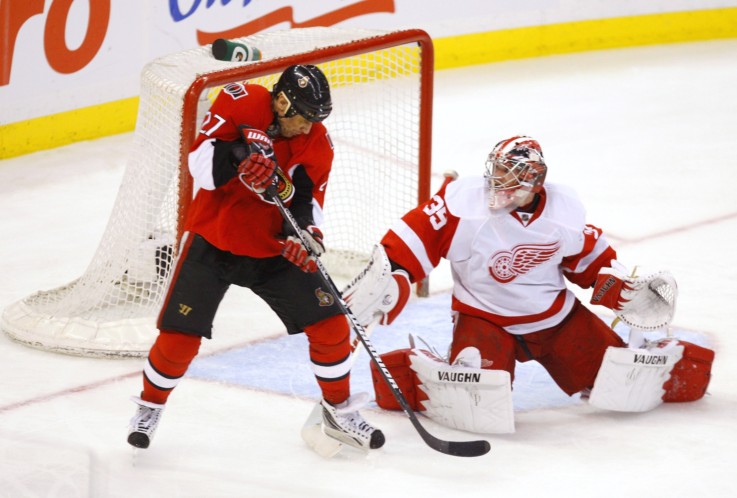 OTTAWA, CANADA - FEBRUARY 02:  Jimmy Howard #35 of the Detroit Red Wings makes a stick save deflecting the puck up into the equipment of Alex Kovalev #27 of the Ottawa Senators in a game at Scotiabank Place on February 2, 2011 in Ottawa, Ontario, Canada. 
