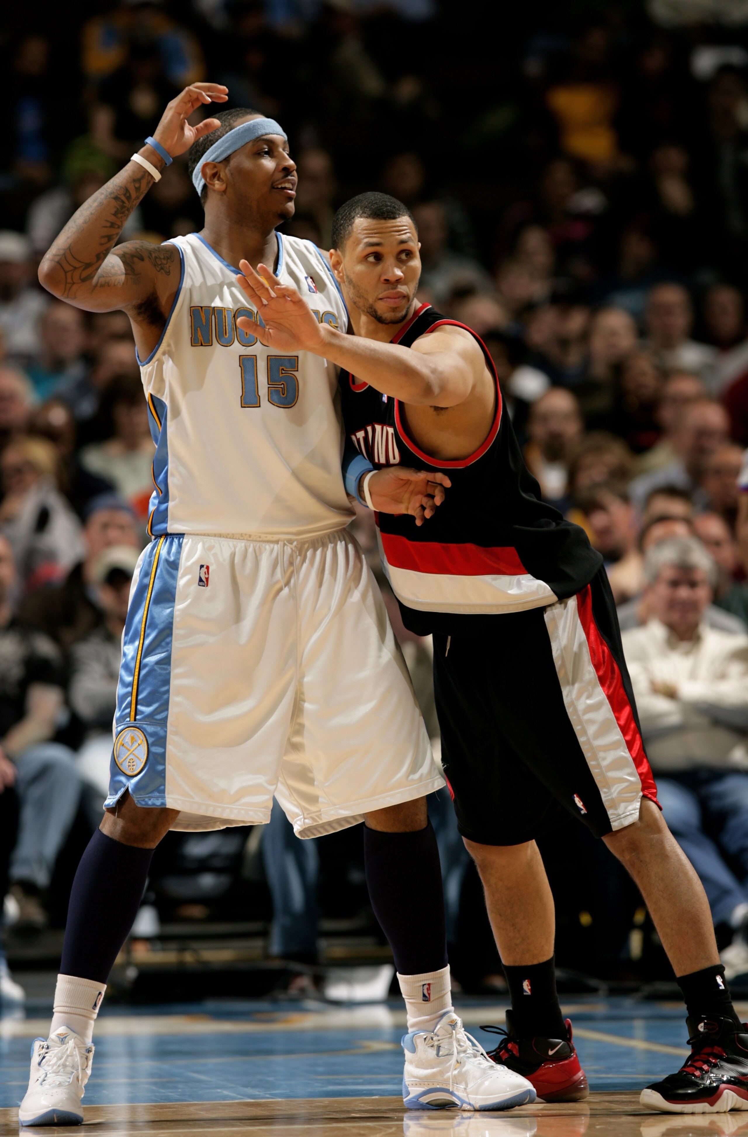 DENVER - MARCH 05:  Carmelo Anthony #15 of the Denver Nuggets looks for the ball as Brandon Roy #7 of the Portland Trail Blazers defends during NBA action at the Pepsi Center on March 5, 2009 in Denver, Colorado. The Nuggets defeated the Trail Blazers 106