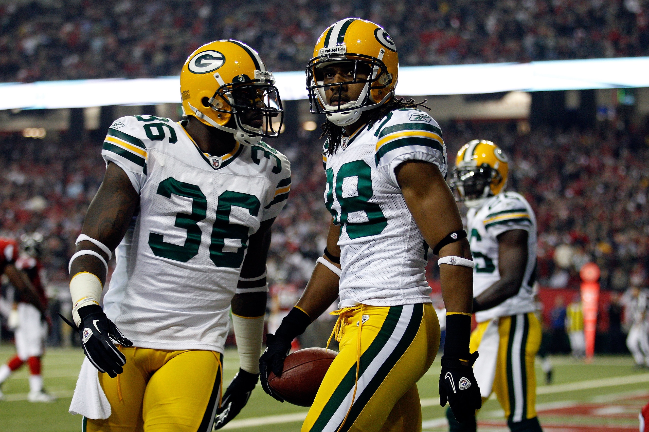 ATLANTA, GA - JANUARY 15:  Tramon Williams (R) #38 and Nick Collins #36 of the Green Bay Packers react after Williams intercepted a pass in the endzone against the Atlanta Falcons during their 2011 NFC divisional playoff game at Georgia Dome on January 15