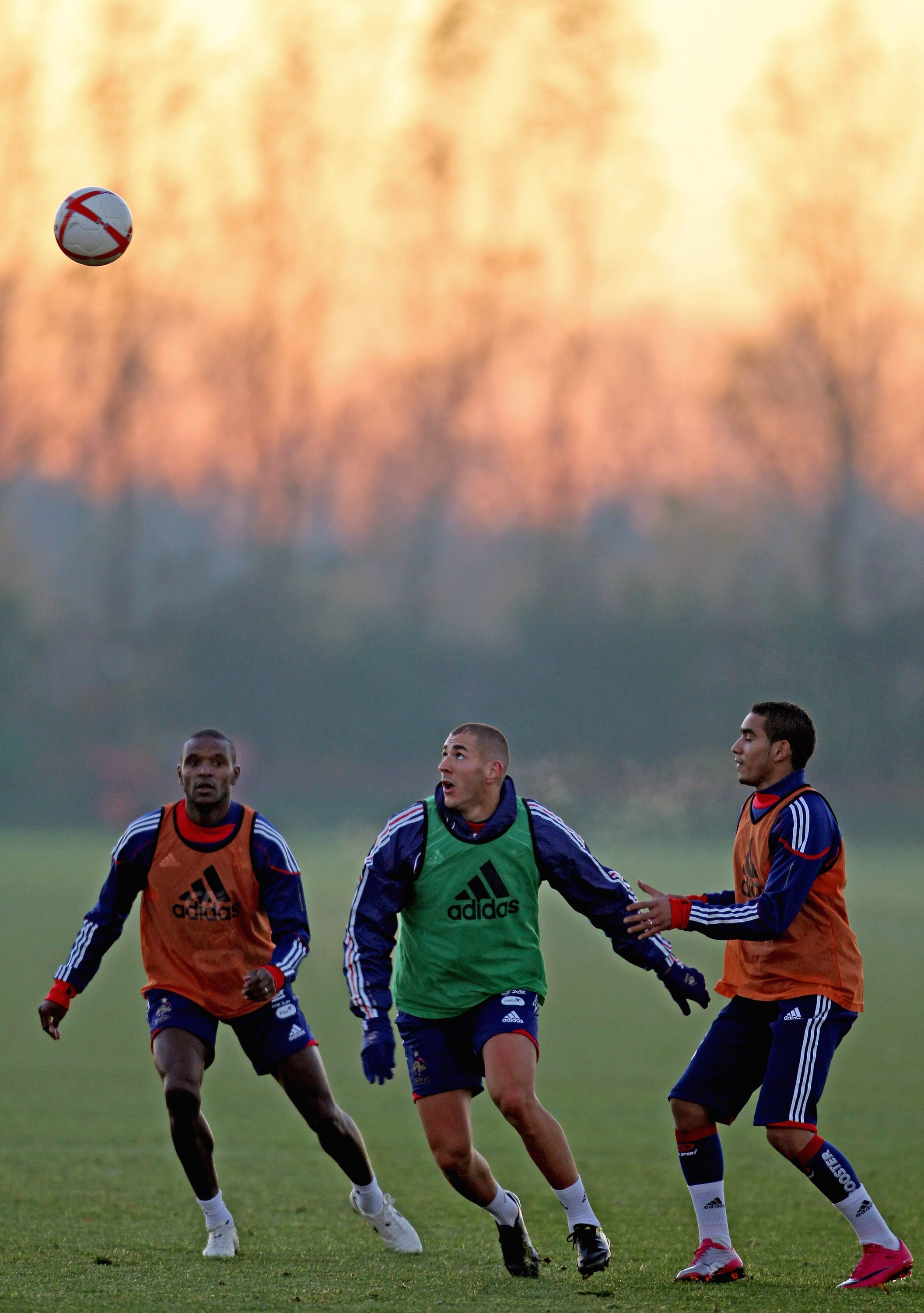 LONDON COLNEY, ENGLAND - NOVEMBER 15: Eric Abidal (L), Dimitri Payet (R) and Karim Benzema (C) in action during a France training session ahead of their international match against England on November 15, 2010, London Colney,  England.  (Photo by Scott He