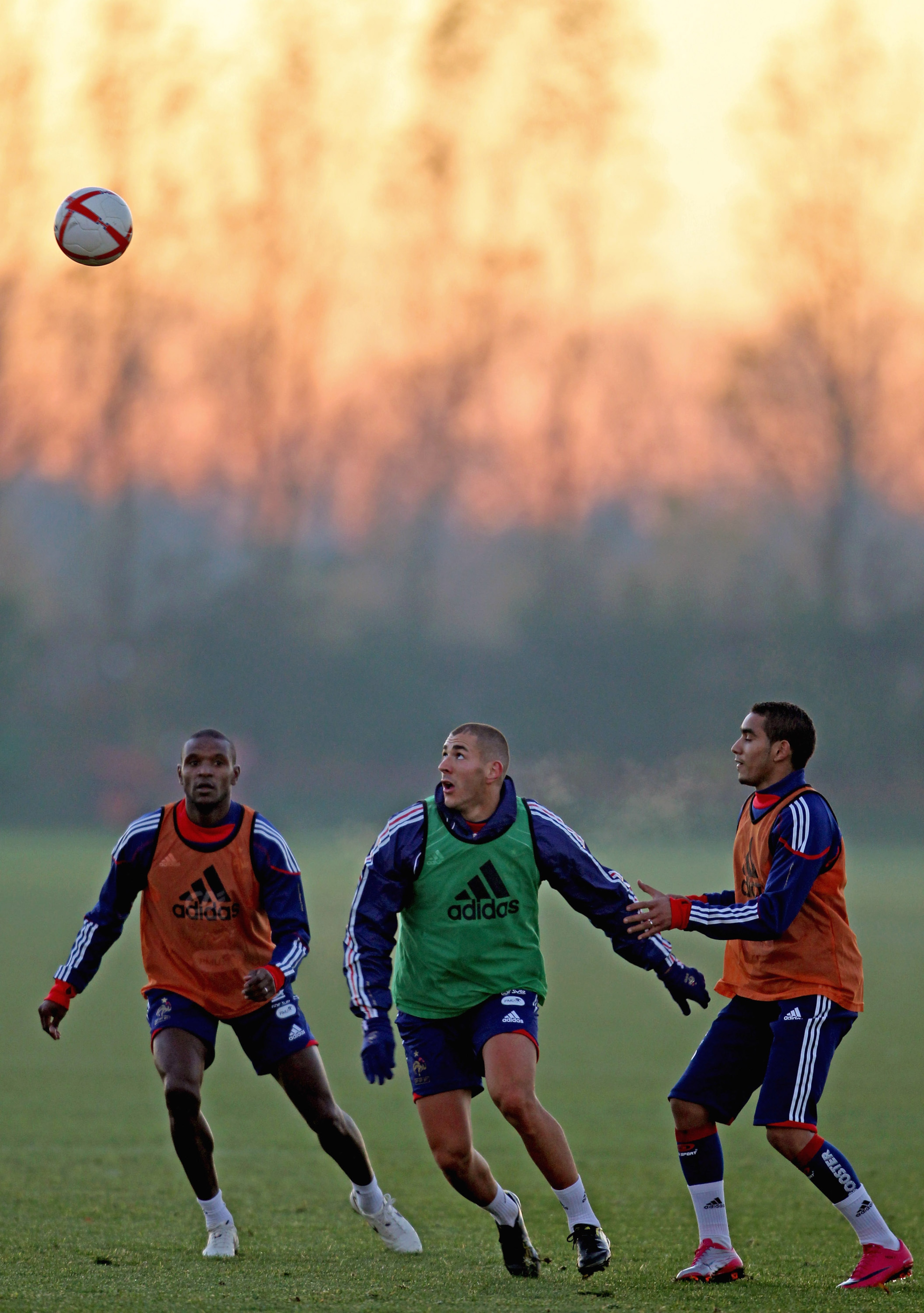 LONDON COLNEY, ENGLAND - NOVEMBER 15: Eric Abidal (L), Dimitri Payet (R) and Karim Benzema (C) in action during a France training session ahead of their international match against England on November 15, 2010, London Colney,  England.  (Photo by Scott He
