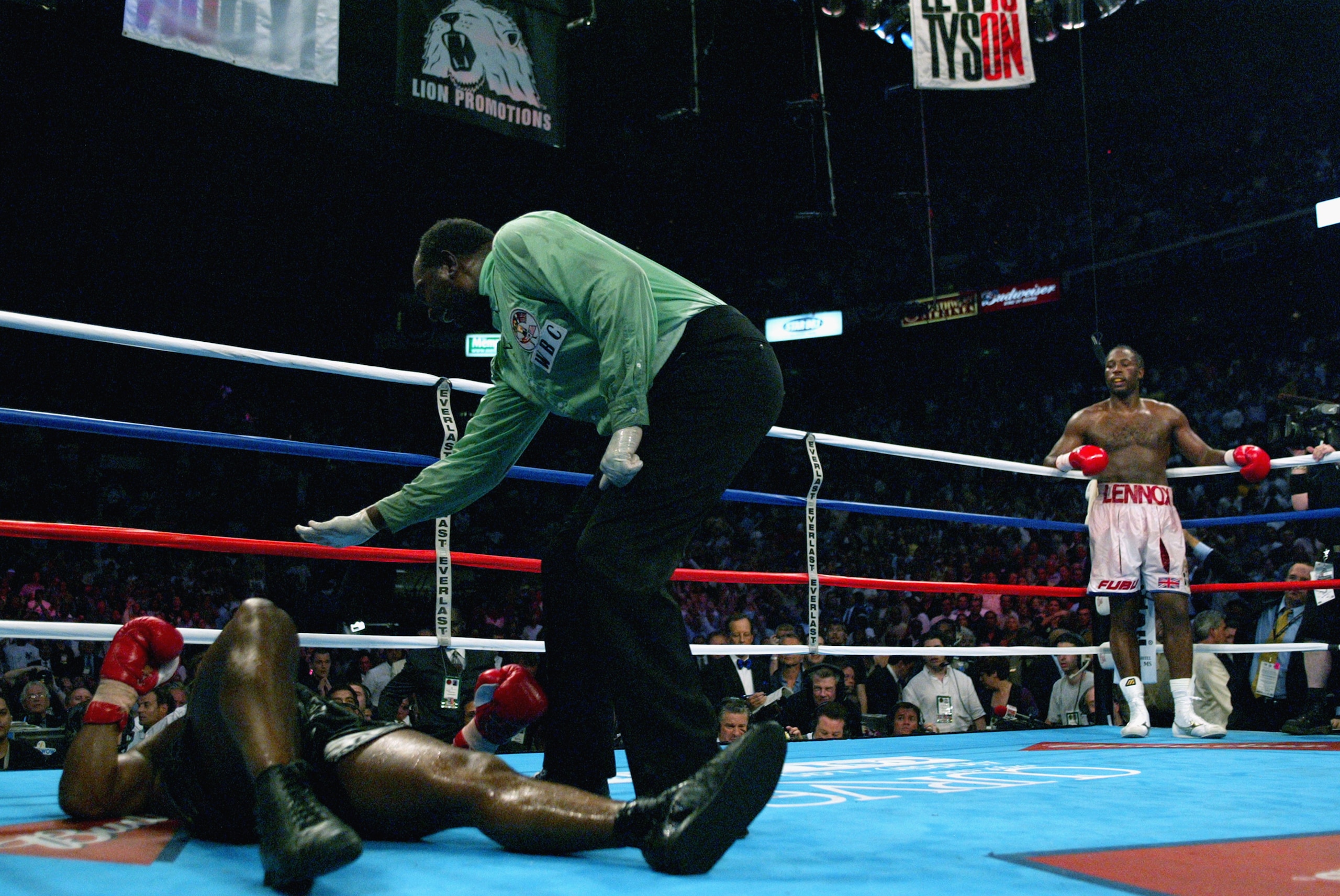 MEMPHIS, TN - JUNE 8:  Mike Tyson is counted out as Lennox Lewis patiently waits in his corner during their WBC/IBF heavyweight championship bout on June 8, 2002 at The Pyramid in Memphis, Tennessee.  Lewis won the bout by way of knockout in the 8th round