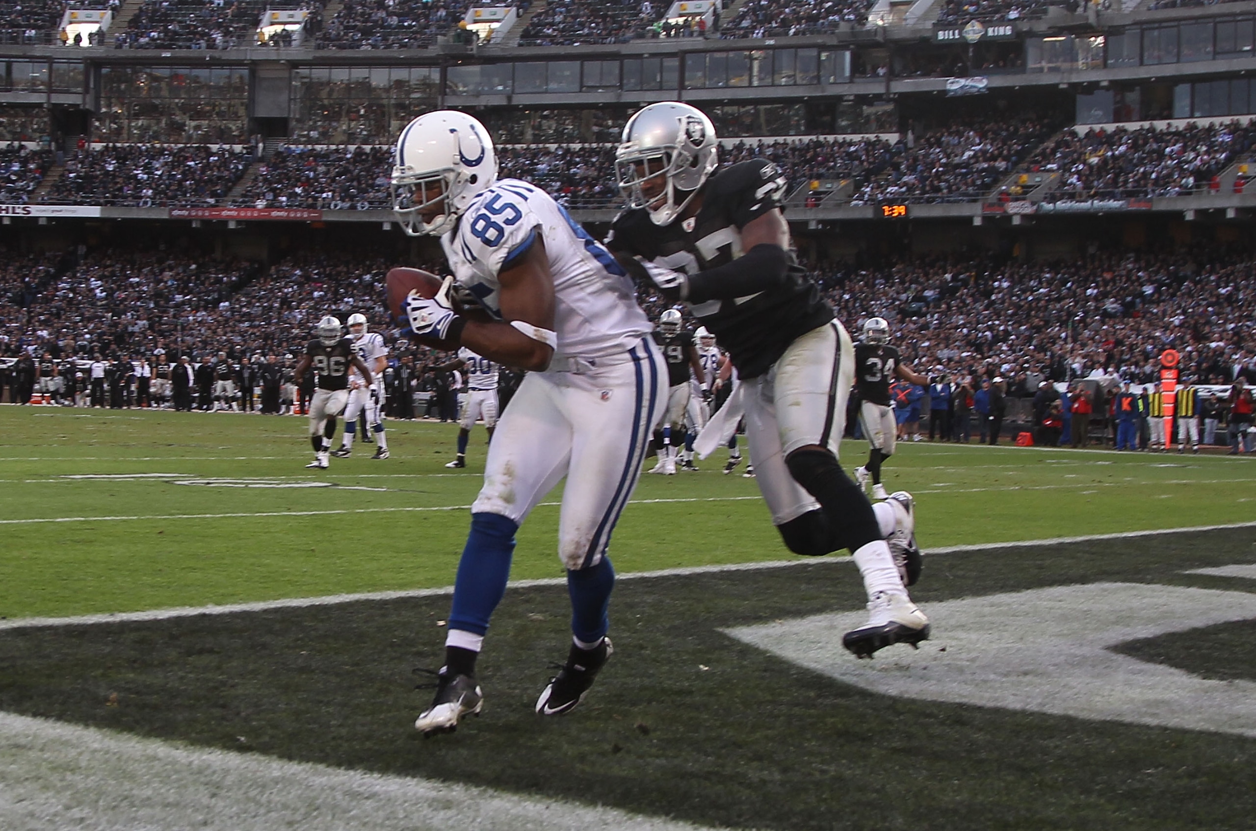 OAKLAND, CA - DECEMBER 26:  Pierre Garcon #85 of the Indianapolis Colts catches a touchdwon past Chris Johnson #37 of the Oakland Raiders during an NFL game at Oakland-Alameda County Coliseum on December  26, 2010 in Oakland, California.  (Photo by Jed Ja