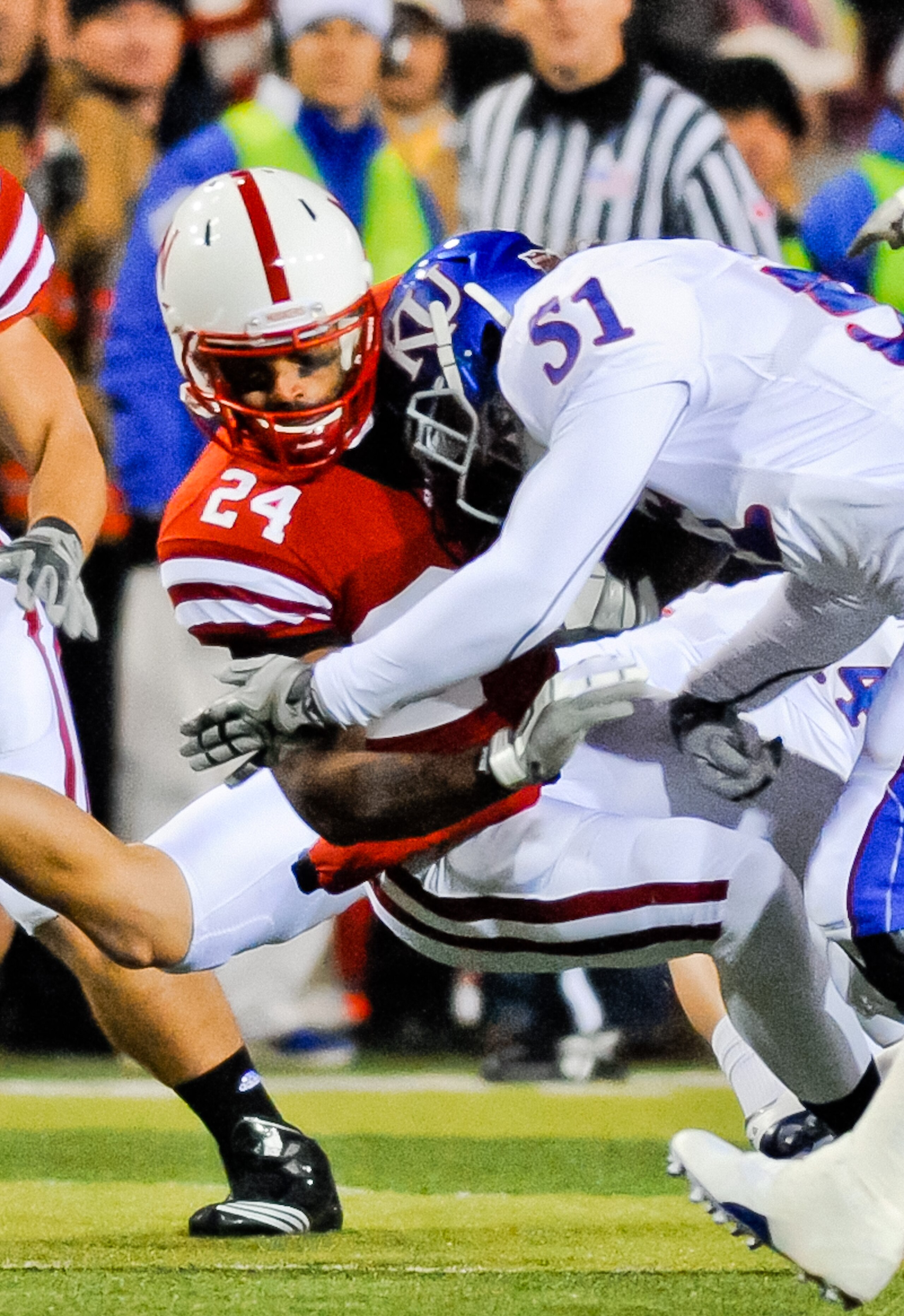 LINCOLN, NE - NOVEMBER 13: Niles Paul #24 of the Nebraska Cornhuskers takes a hit from Dakota Lewis #51 of the Kansas Jayhawks during their game at Memorial Stadium on November 13, 2010 in Lincoln, Nebraska. Nebraska Defeated Kansas 20-3. (Photo by Eric F