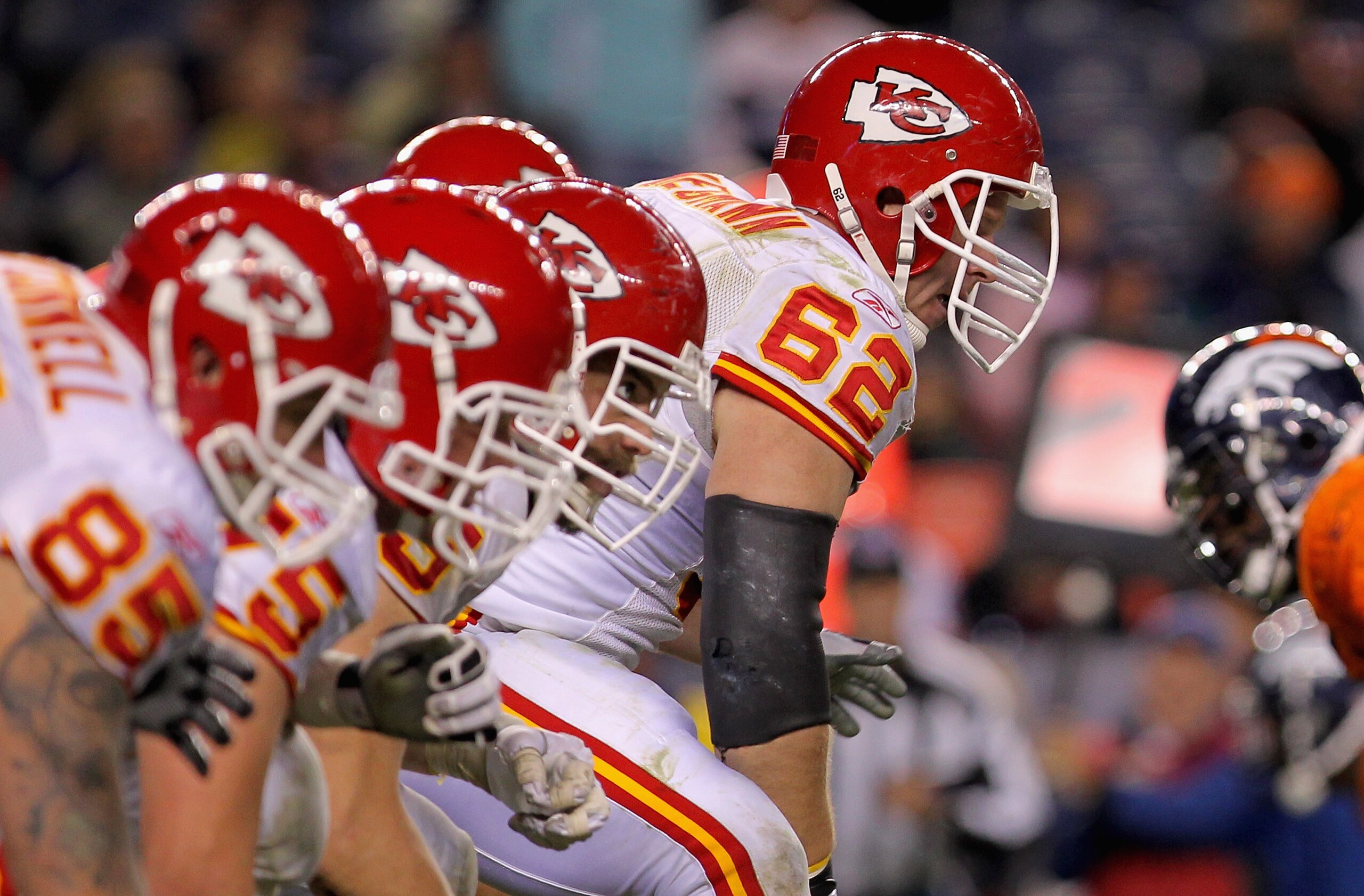 DENVER - NOVEMBER 14:  Center Casey Wiegman #62 of the Kansas City Chiefs snaps the ball as the Chiefs offensive line takes on the defensive line of the Denver Bronco at INVESCO Field at Mile High on November 14, 2010 in Denver, Colorado. The Broncos defe