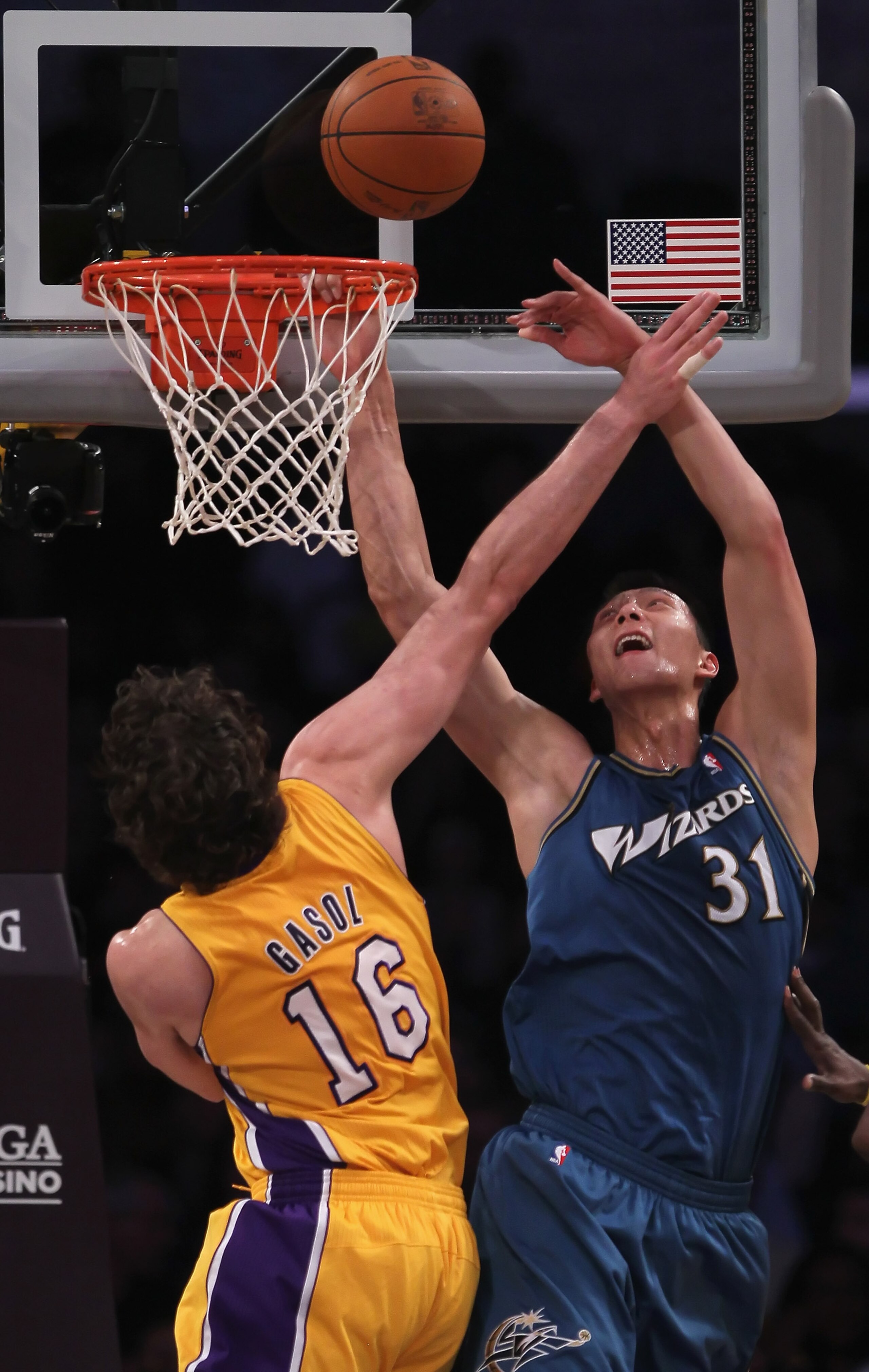 LOS ANGELES, CA - DECEMBER 07:  Yi Jianlian #31 of the Washington Wizards is fouled by Pau Gasol #16 of the Los Angeles Lakers while driving to the basket in the first half at Staples Center on December 7, 2010 in Los Angeles, California. NOTE TO USER: Us