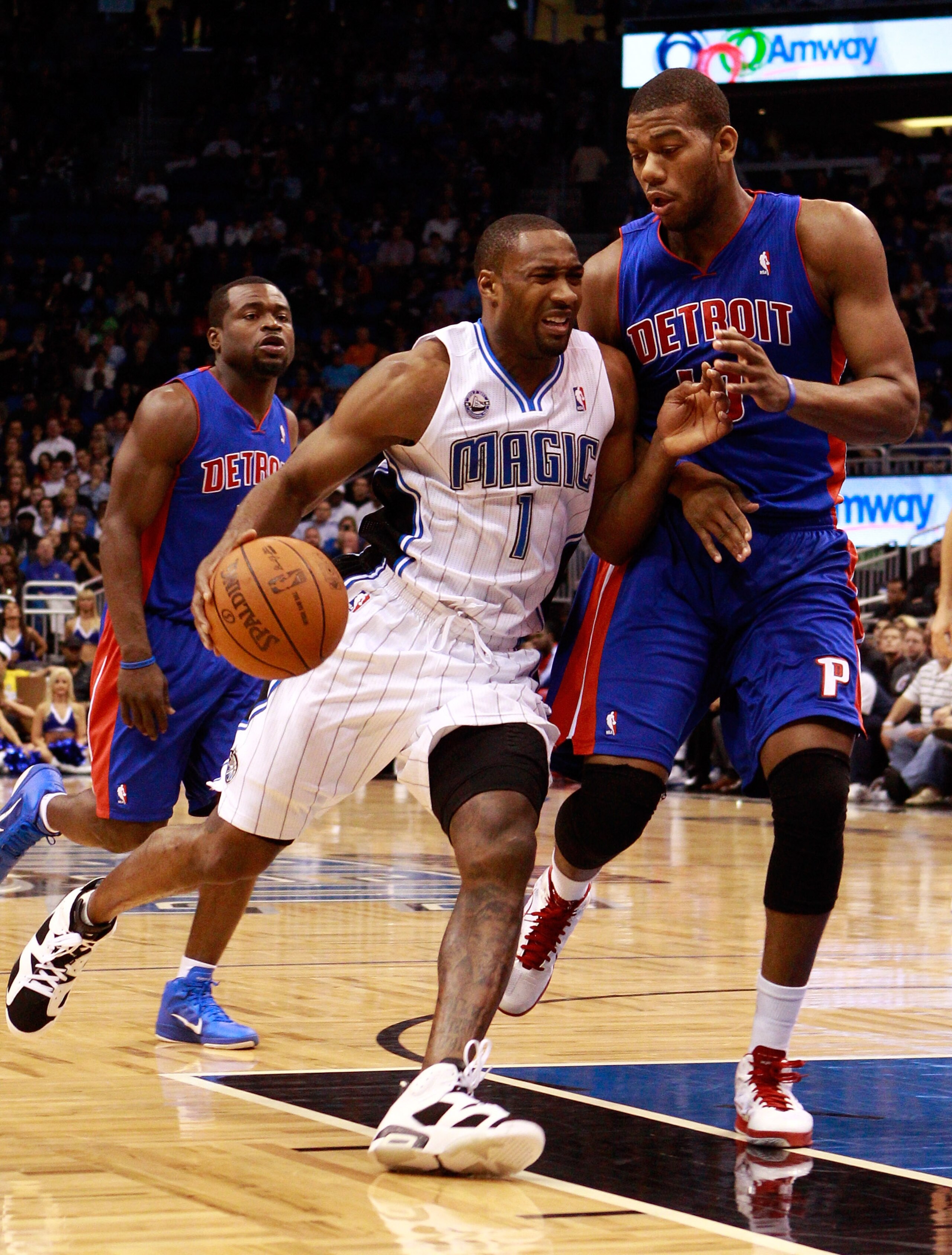 ORLANDO, FL - JANUARY 24:  Gilbert Arenas #1 of the Orlando Magic drives against Greg Monroe #10 of the Detroit Pistons during the game at Amway Arena on January 24, 2011 in Orlando, Florida.  NOTE TO USER: User expressly acknowledges and agrees that, by 