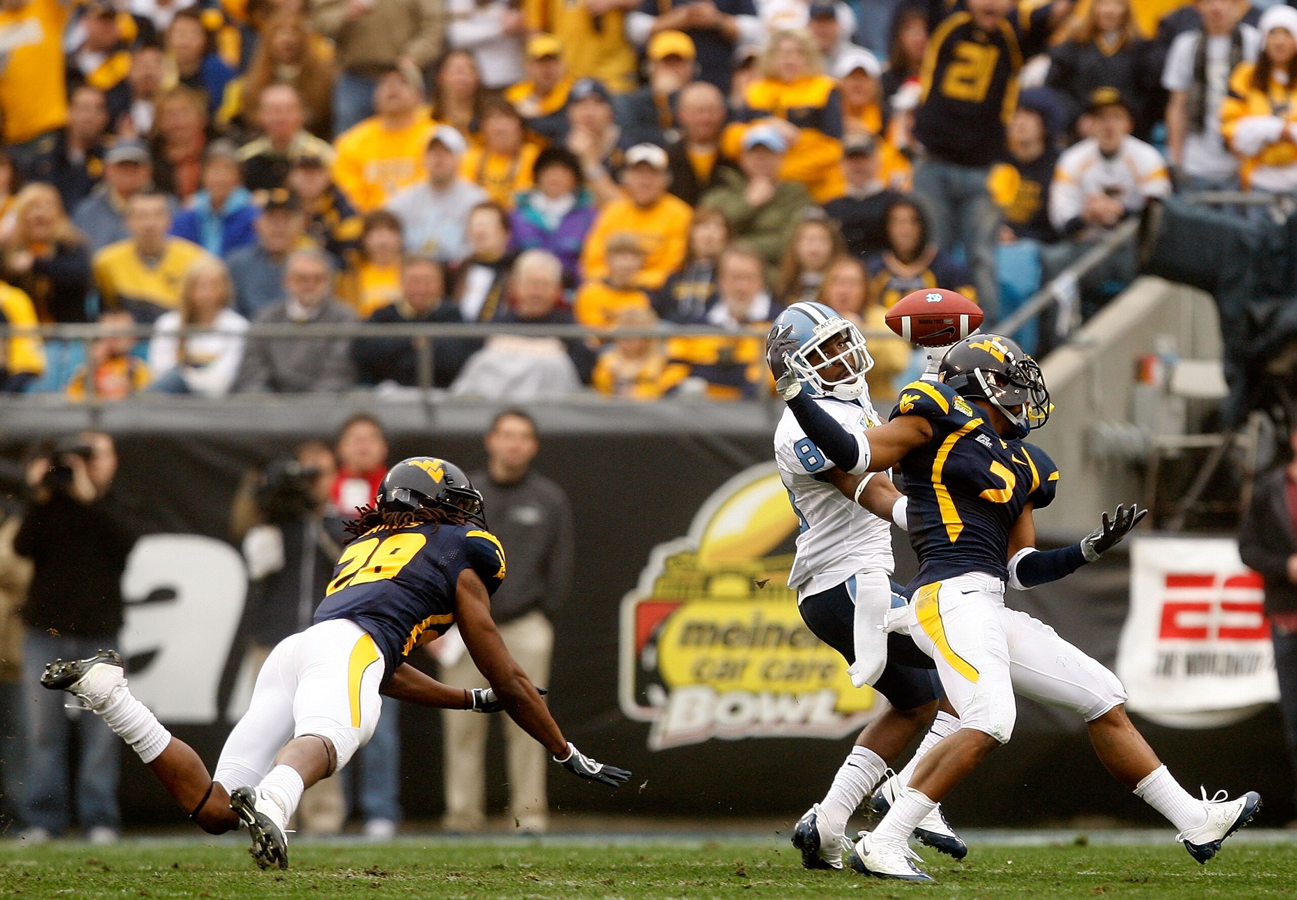 CHARLOTTE, NC - DECEMBER 27:  Hakeem Nicks #88 of the North Carolina Tar Heels catches a touchdown over Ellis Lankster #2 and teammate Robert Sands #28 of the West Virginia Mountaineers during the Meineke Car Care Bowl on December 27, 2008 at Bank of Amer