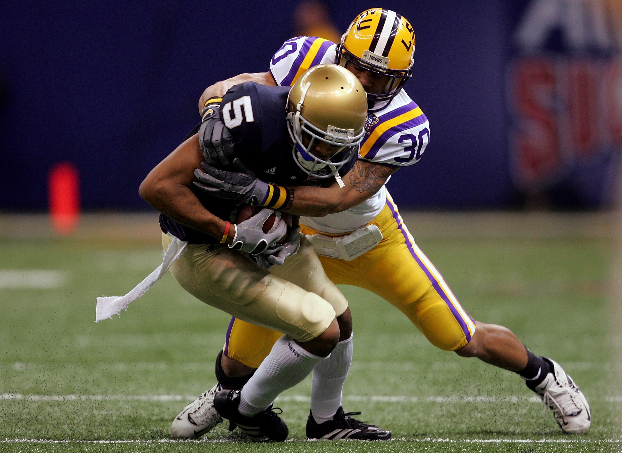 NEW ORLEANS - JANUARY 03:  LaRon Landry #30 of the LSU Tigers tackles Rhema McKnight #5 of the Notre Dame Fighting Irish during the 2007 Allstate Sugar Bowl on January 3, 2007 at the Superdome in New Orleans, Louisiana.  LSU won the game 41-14.  (Photo by