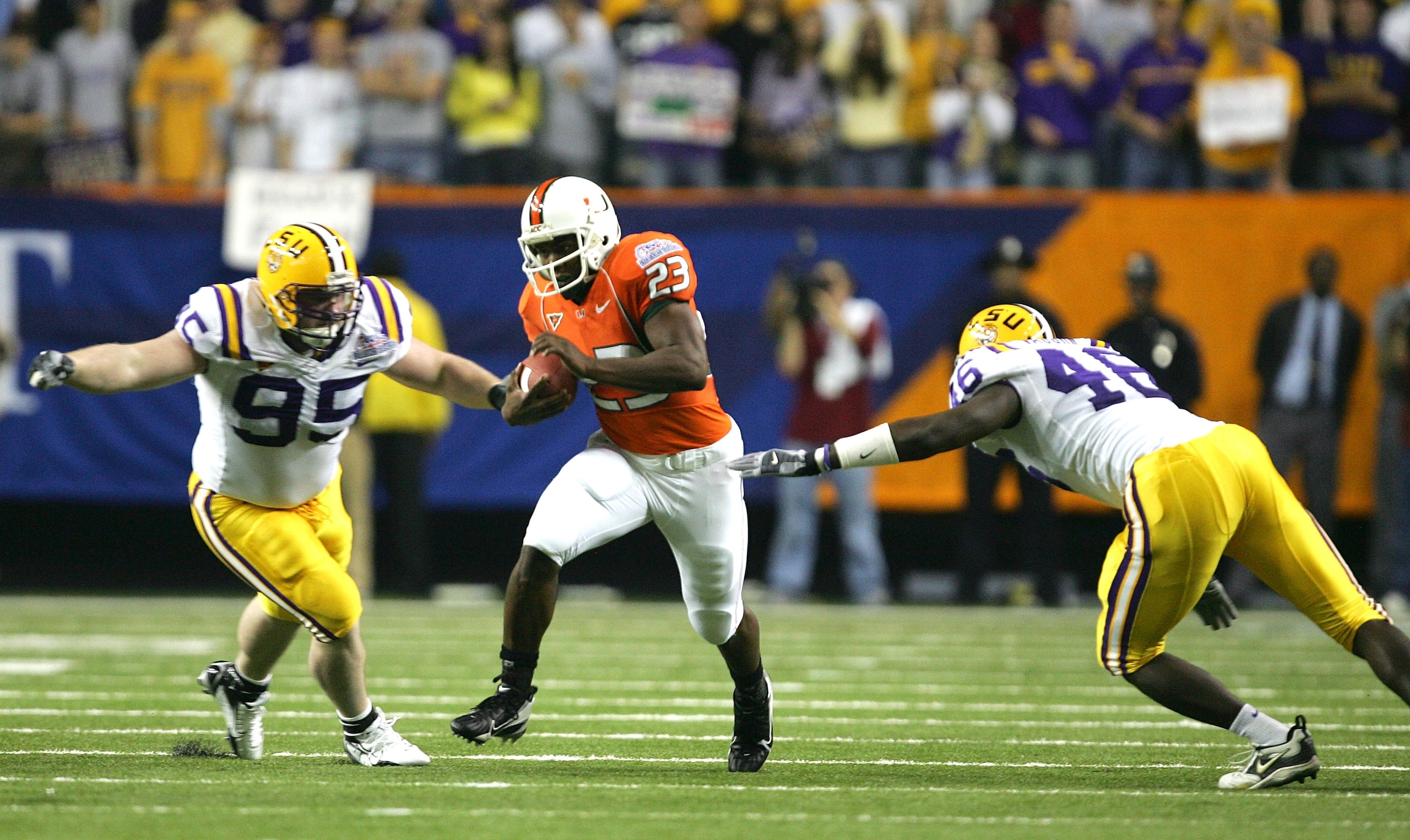 ATLANTA - DECEMBER 30:  Fullback Quadtrine Hill #23 of the Miami Hurricanes runs against the defense of Kyle Williams #95 of the LSU Tigers during the Chick-fil-A Peach Bowl on December 30, 2005 at the Georgia Dome in Atlanta, Georgia.  (Photo by Streeter
