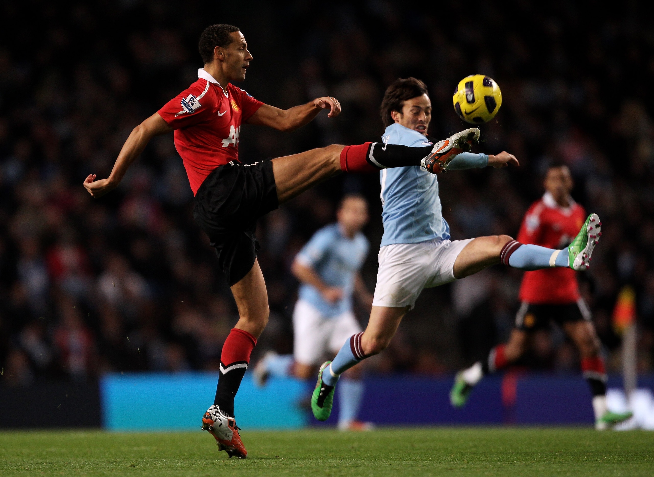 MANCHESTER, UNITED KINGDOM - NOVEMBER 10:   Rio Ferdinand of Manchester United competes with David Silva of Manchester City during the Barclays Premier League match between Manchester City and Manchester United at the City of Manchester Stadium on Novembe