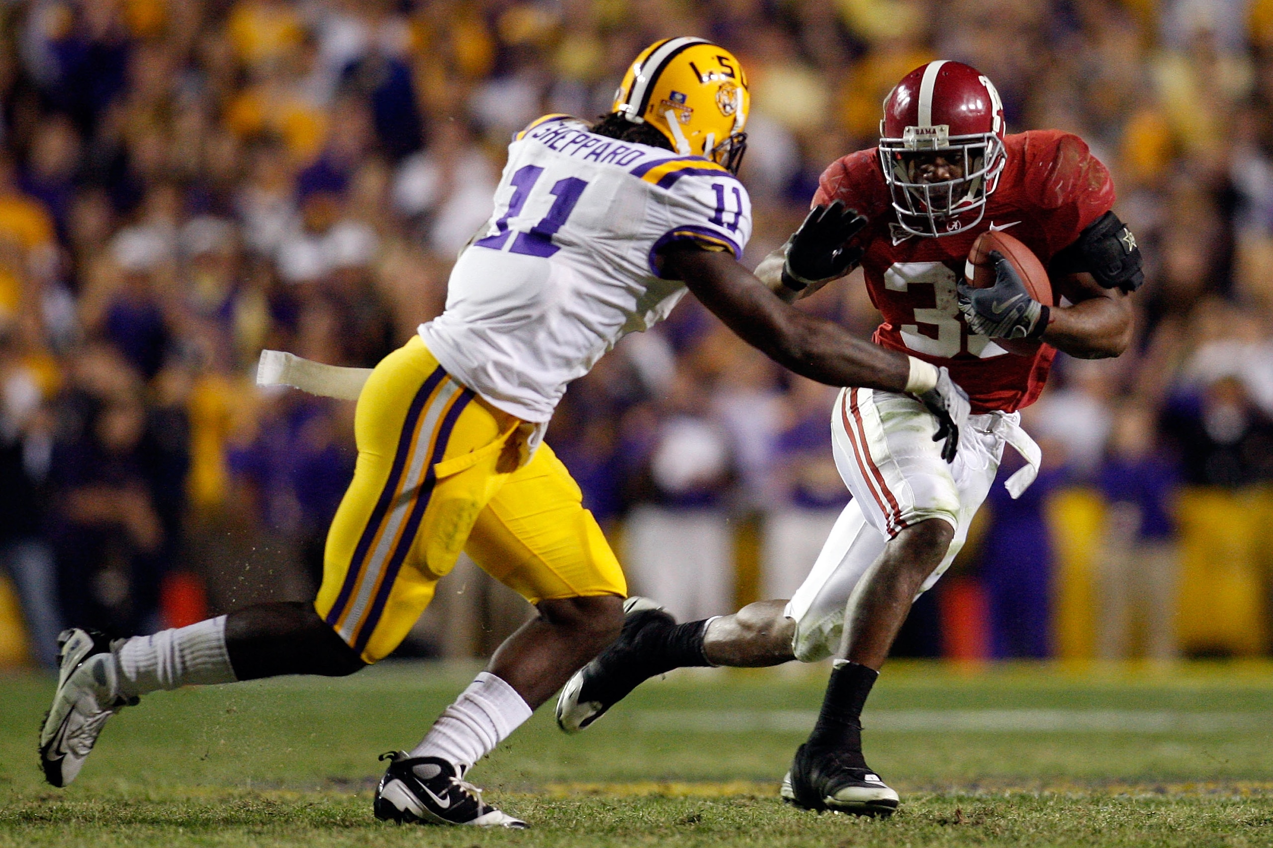 BATON ROUGE, LA - NOVEMBER 08:  Glen Coffee #38 of the Alabama Crimson Tide tries to avoid a tackle by Kelvin Sheppard #11 of the Louisiana State University Tigers on November 11, 2008 at Tiger Stadium in Baton Rouge, Louisiana. The Tide defeated the Tige