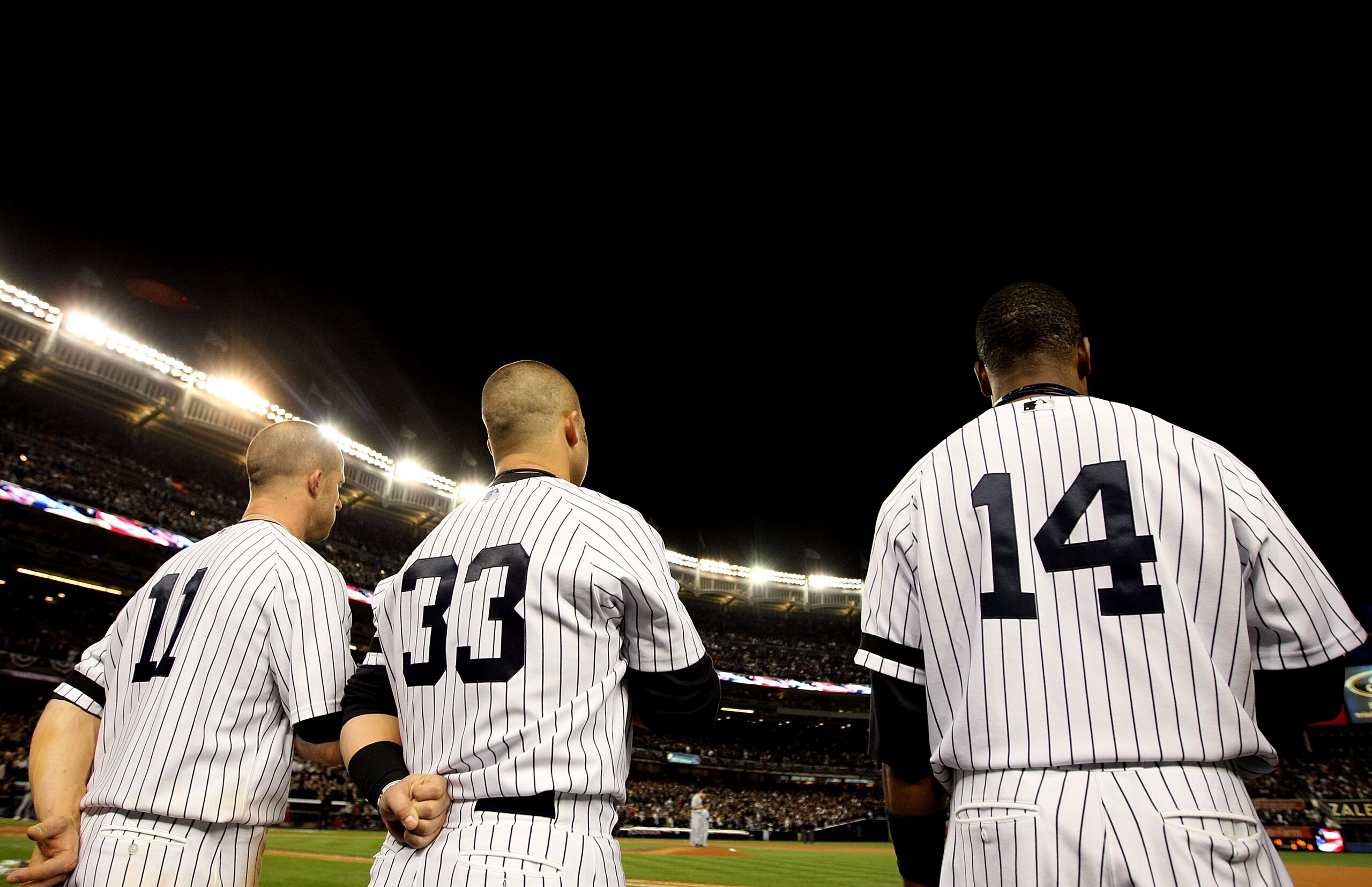 NEW YORK - OCTOBER 18:  (L-R) Brett Gardner #11, Nick Swisher #33 and Curtis Granderson #14 of the New York Yankees stand for the performance of 'God Bless America'  against the Texas Rangers in Game Three of the ALCS during the 2010 MLB Playoffs at Yanke