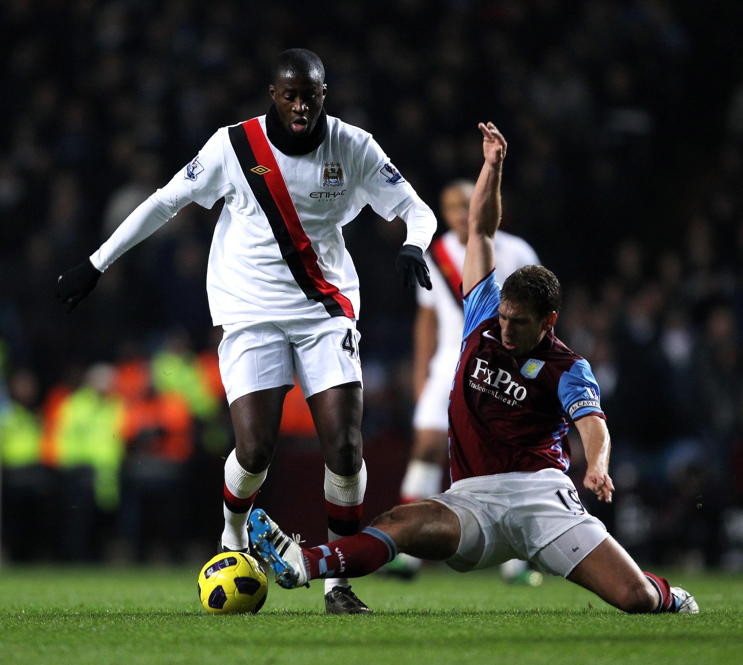 BIRMINGHAM, ENGLAND - JANUARY 22:  Yaya Toure of Manchester City is tackled by Stiliyan Petrov of Aston Villa during the Barclays Premier League match between Aston Villa and Manchester City at Villa Park on January 22, 2011 in Birmingham, England.  (Phot