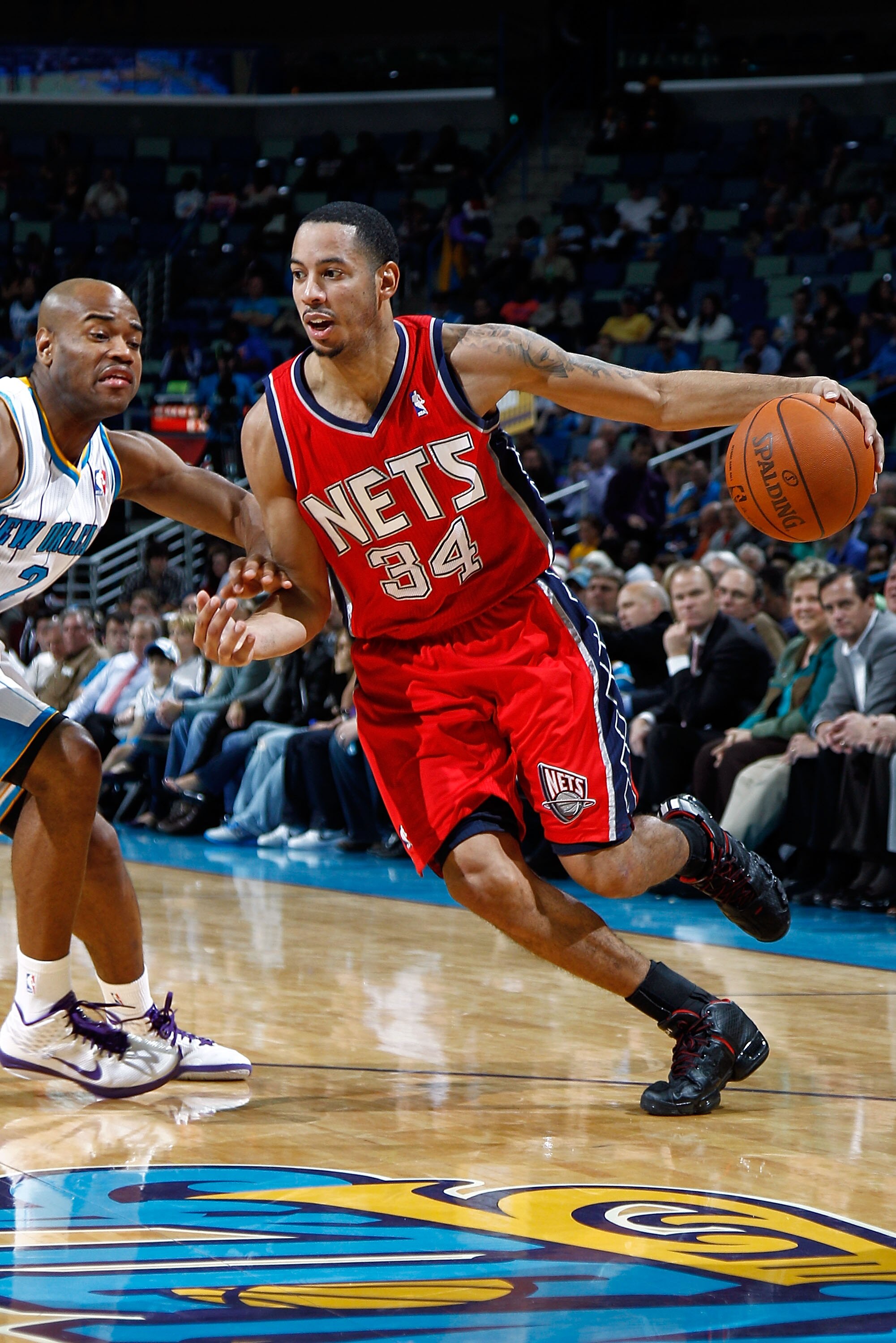 NEW ORLEANS, LA - DECEMBER 22:  Devin Harris #34 of the New Jersey Nets drives the ball around Jarrett Jack #2  of the New Orleans Hornets at the New Orleans Arena on December 22, 2010 in New Orleans, Louisiana.    The Hornets defeated the Nets 105-91.