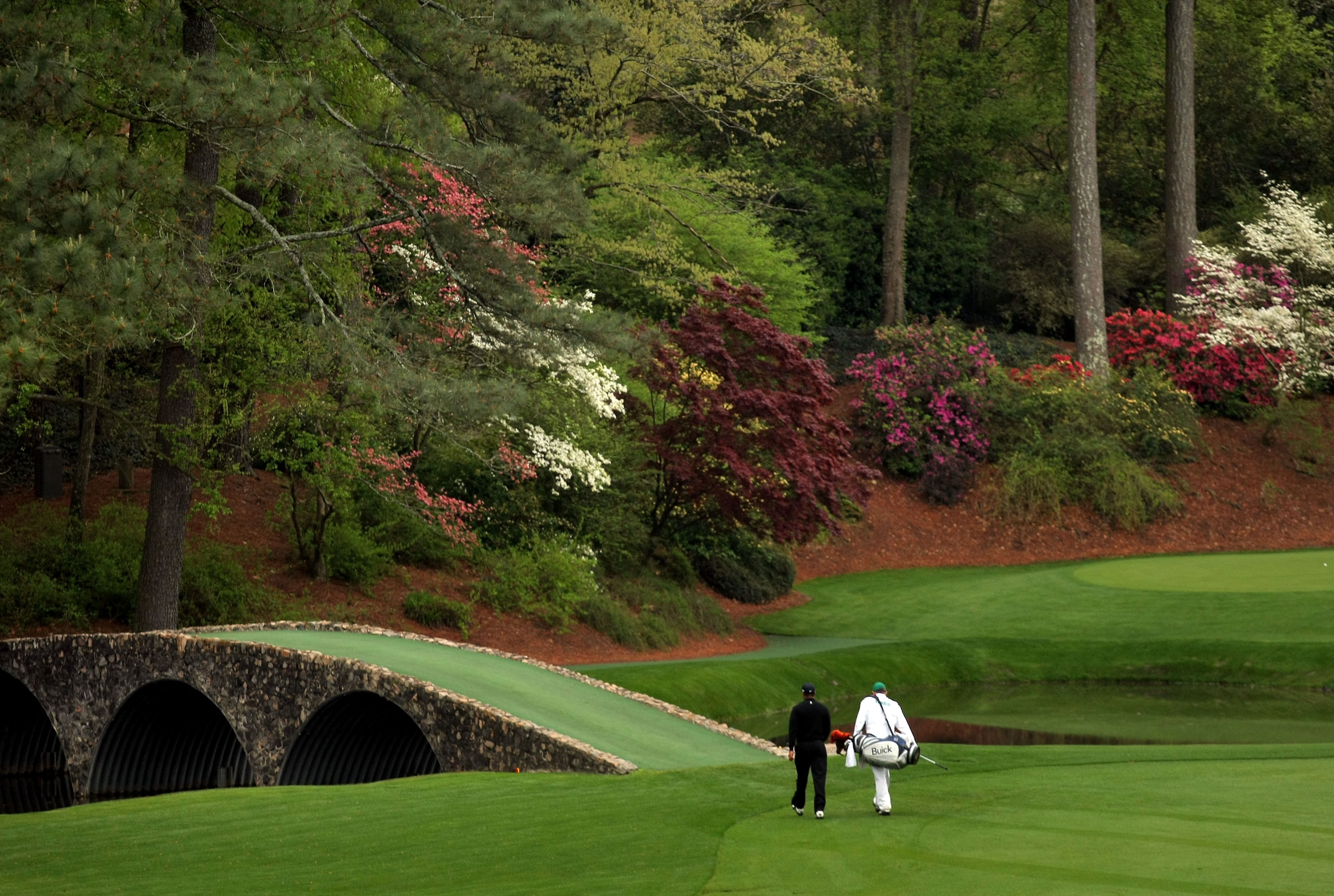 AUGUSTA, GA - APRIL 08:  Tiger Woods walks with caddie Steve Williams towards the Ben Hogan bridge during the second day of practice prior to the start of the 2008 Masters Tournament at Augusta National Golf Club on April 8, 2008 in Augusta, Georgia.  (Ph