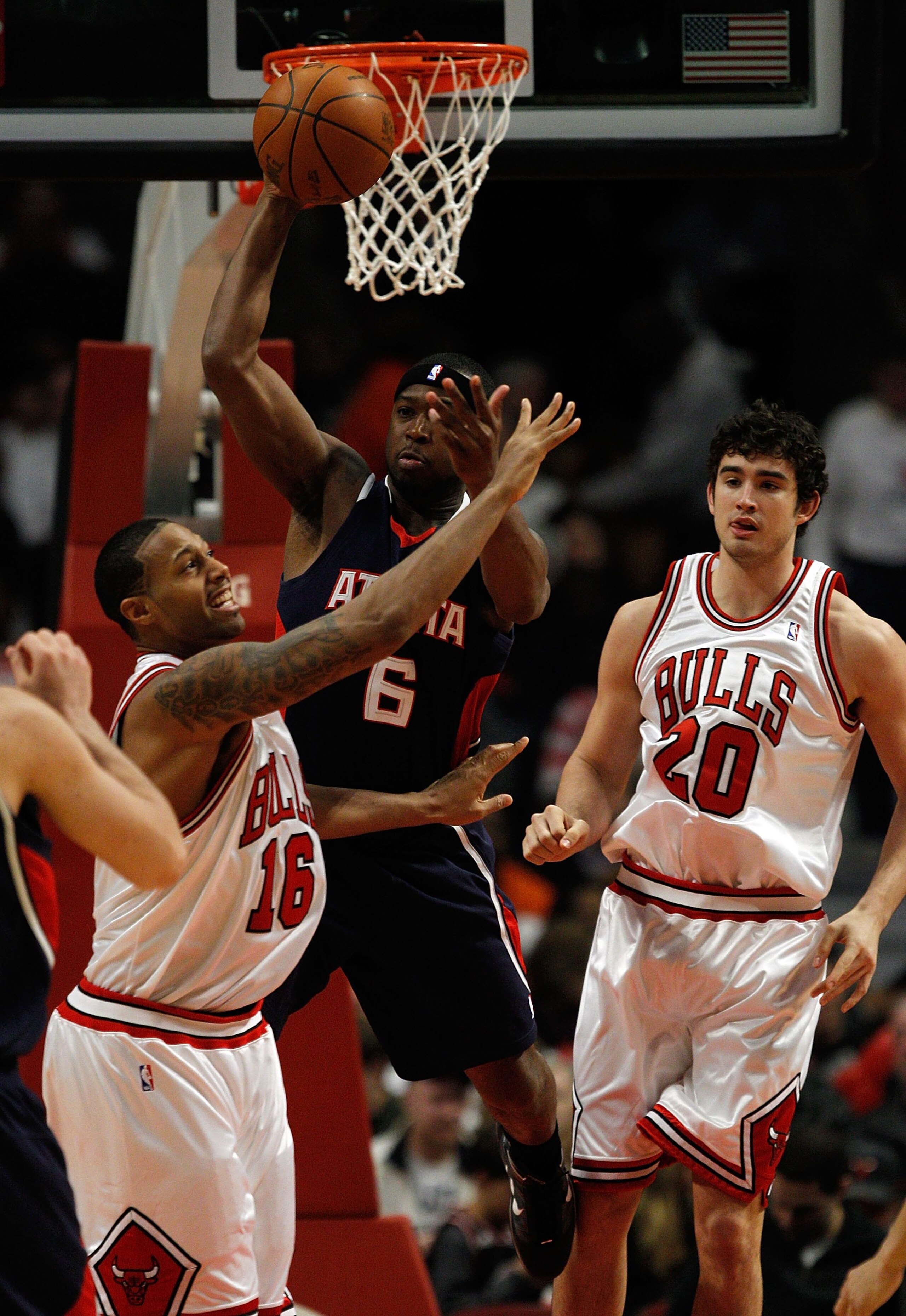 CHICAGO - MARCH 01: Mario West #6 of the Atlanta Hawks passes the ball between James Johnson #16 and Joe Alexander #20 of the Chicago Bulls at the United Center on March 1, 2010 in Chicago, Illinois. The Hawks defeated the Bulls 116-92. NOTE TO USER: User CHICAGO - MARCH 01: Mario West #6 of the Atlanta Hawks passes the ball between James Johnson #16 and Joe Alexander #20 of the Chicago Bulls at the United Center on March 1, 2010 in Chicago, Illinois. The Hawks defeated the Bulls 116-92. NOTE TO USER: User