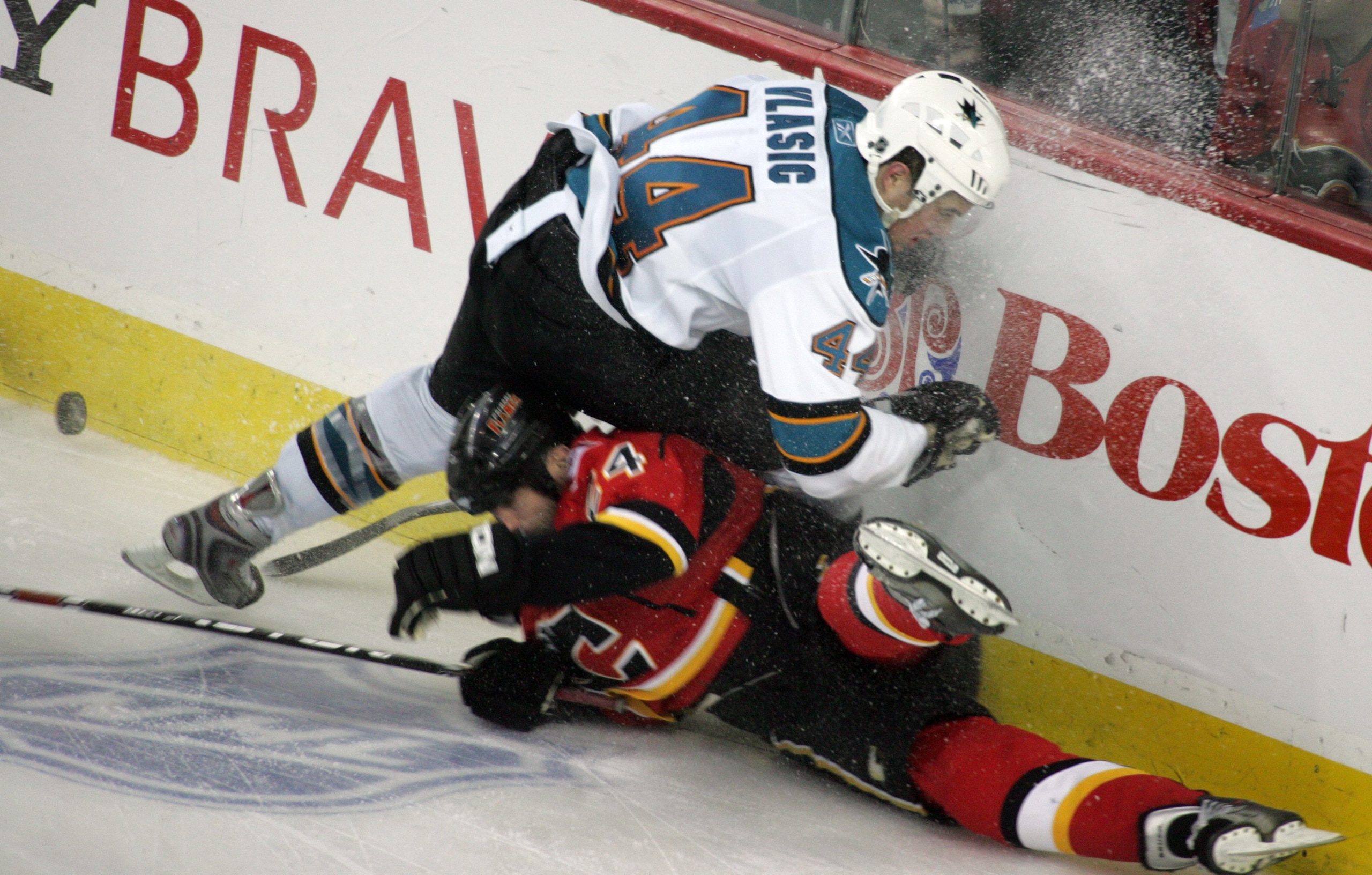 CALGARY, CANADA - APRIL 20: Craig Conroy #24 of the Calgary Flames can't beat Marc-Edouard Vlasic #44 of the San Jose Sharks to the puck for an icing call during Game 6 of the 2008 NHL Stanley Cup Playoffs Western Conference Quarterfinals at Pengrowth Sad