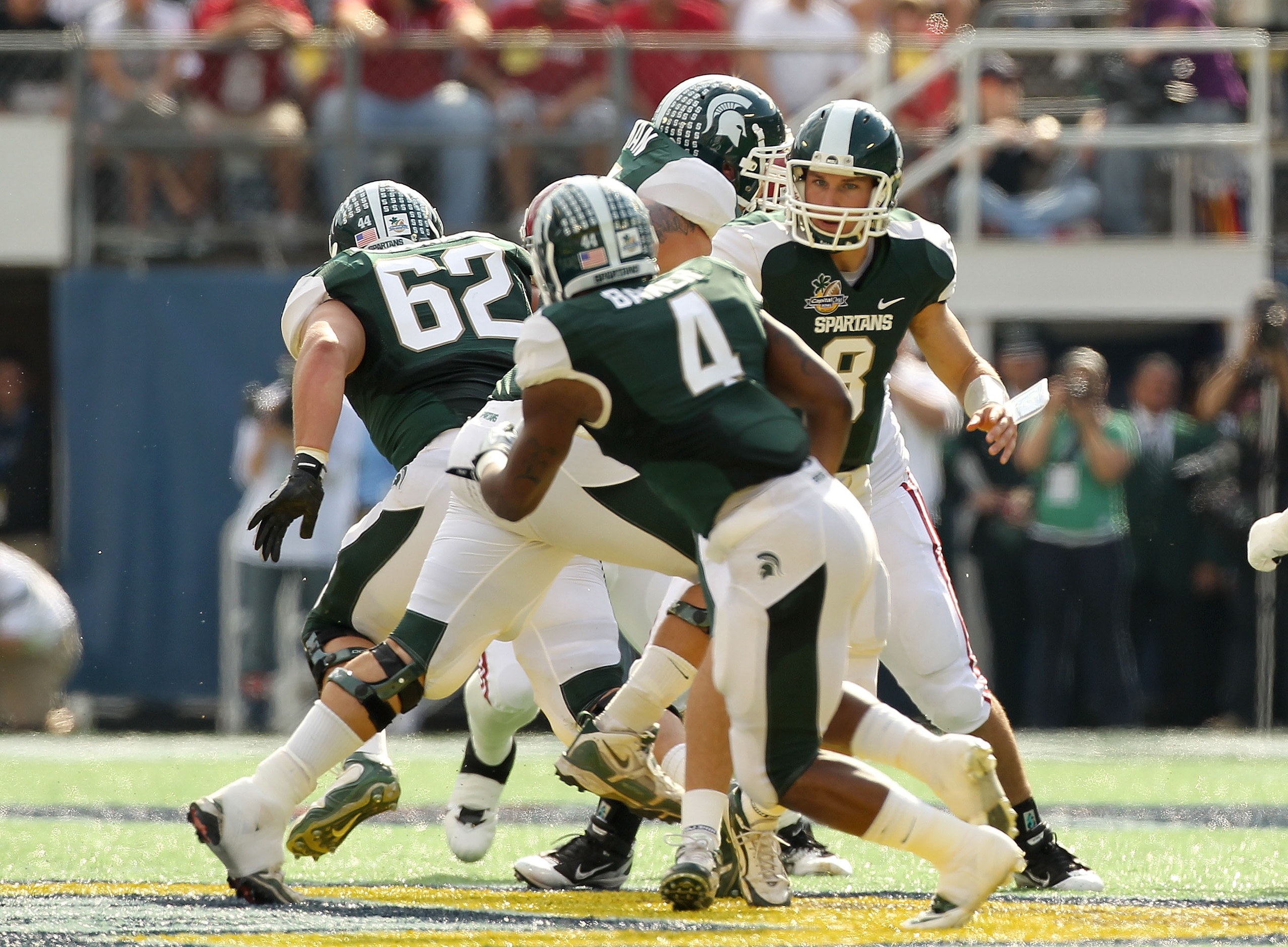 ORLANDO, FL - JANUARY 01: Kirk Cousins #8 of the Michigan State Spartans hands the ball off to Edwin Baker #4 during the Capitol One Bowl against the Alabama Crimson Tide at the Florida Citrus Bowl on January 1, 2011 in Orlando, Florida. (Photo by Mike ORLANDO, FL - JANUARY 01: Kirk Cousins #8 of the Michigan State Spartans hands the ball off to Edwin Baker #4 during the Capitol One Bowl against the Alabama Crimson Tide at the Florida Citrus Bowl on January 1, 2011 in Orlando, Florida. (Photo by Mike