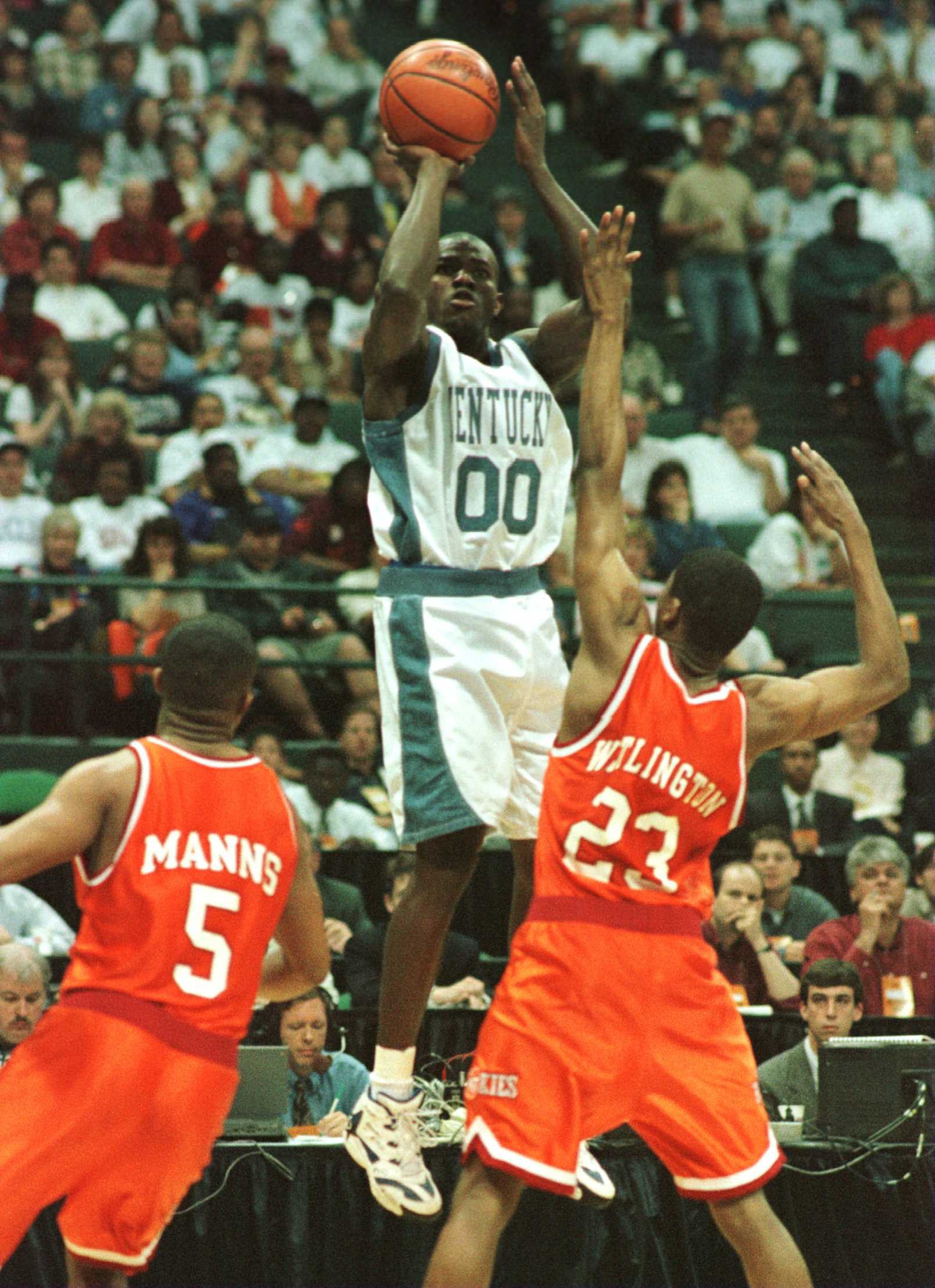 16 Mar 1996:  Tony Delk #00 of Kentucky puts up a shot over Troy Manns #5 and Damon Wallington #23 of Virginia Tech during the second round of the NCAA Midwest Regional Men''s Basketball Tournament played at Renunion Arena in Dallas, Texas. Kentucky defea