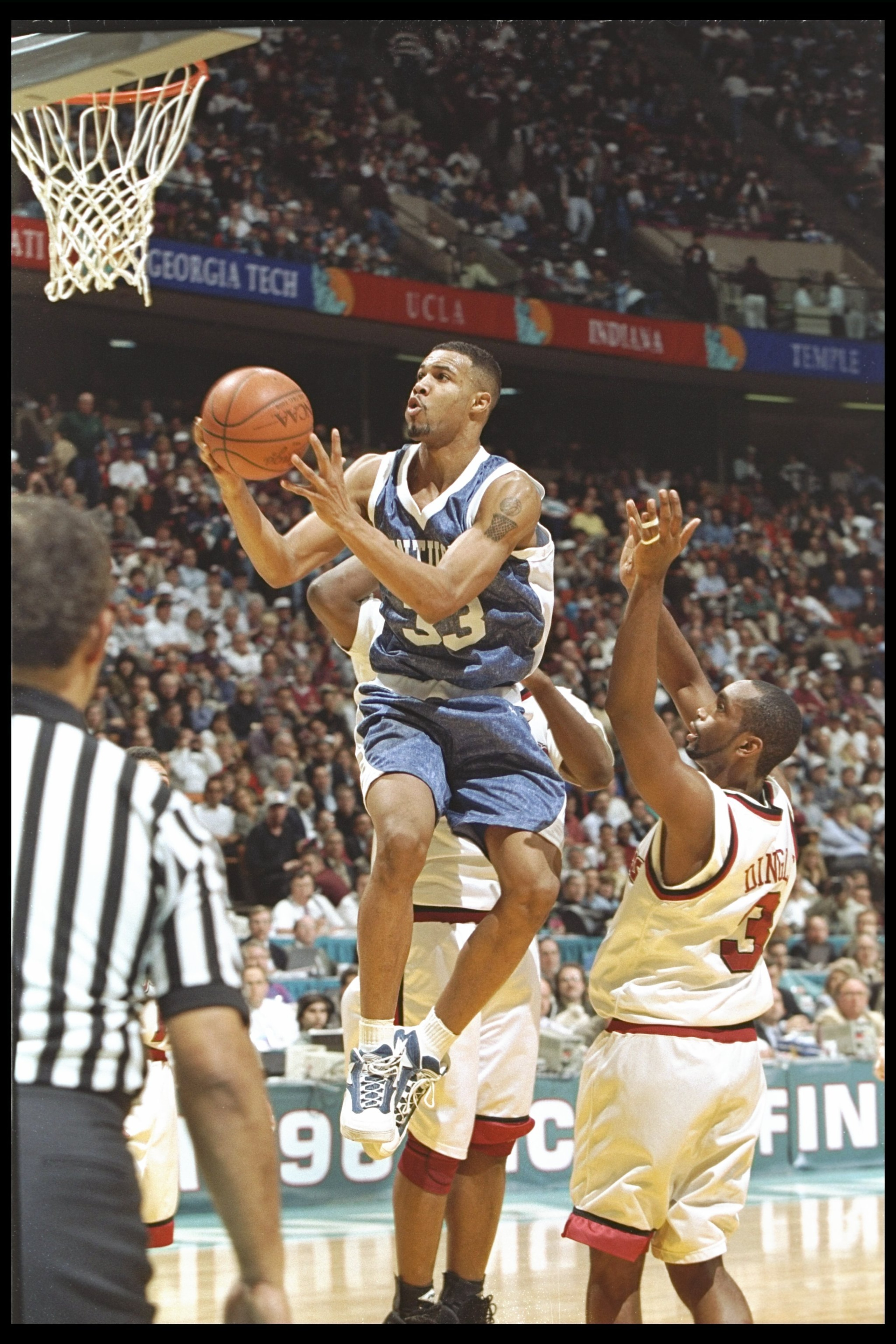 30 Mar 1996:  Guard Ron Mercer of the Kentucky Wildcats goes up for two against Dana Dingel of the Massachusetts Minutemen during a game at the Meadowlands in East Rutherford, New Jersey.  Kentucky won the game, 81-74. Mandatory Credit: Doug Pensinger/All