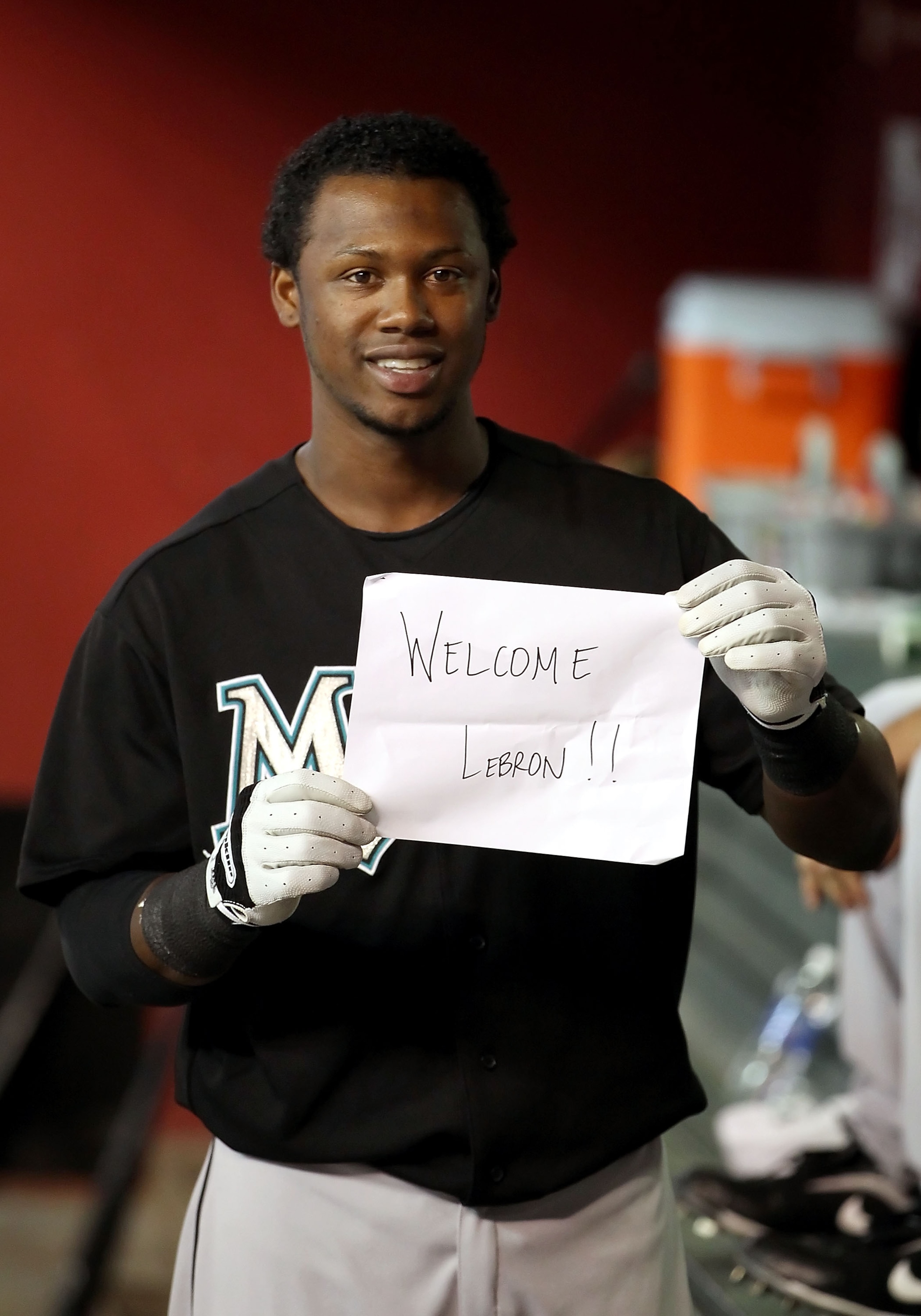 PHOENIX - JULY 08:  Hanley Ramirez #2 of the Florida Marlins holds up a 'Welcome LeBron' sign for television and phototographers in the dugout before before the Major League Baseball game against the Arizona Diamondbacks at Chase Field on July 8, 2010 in
