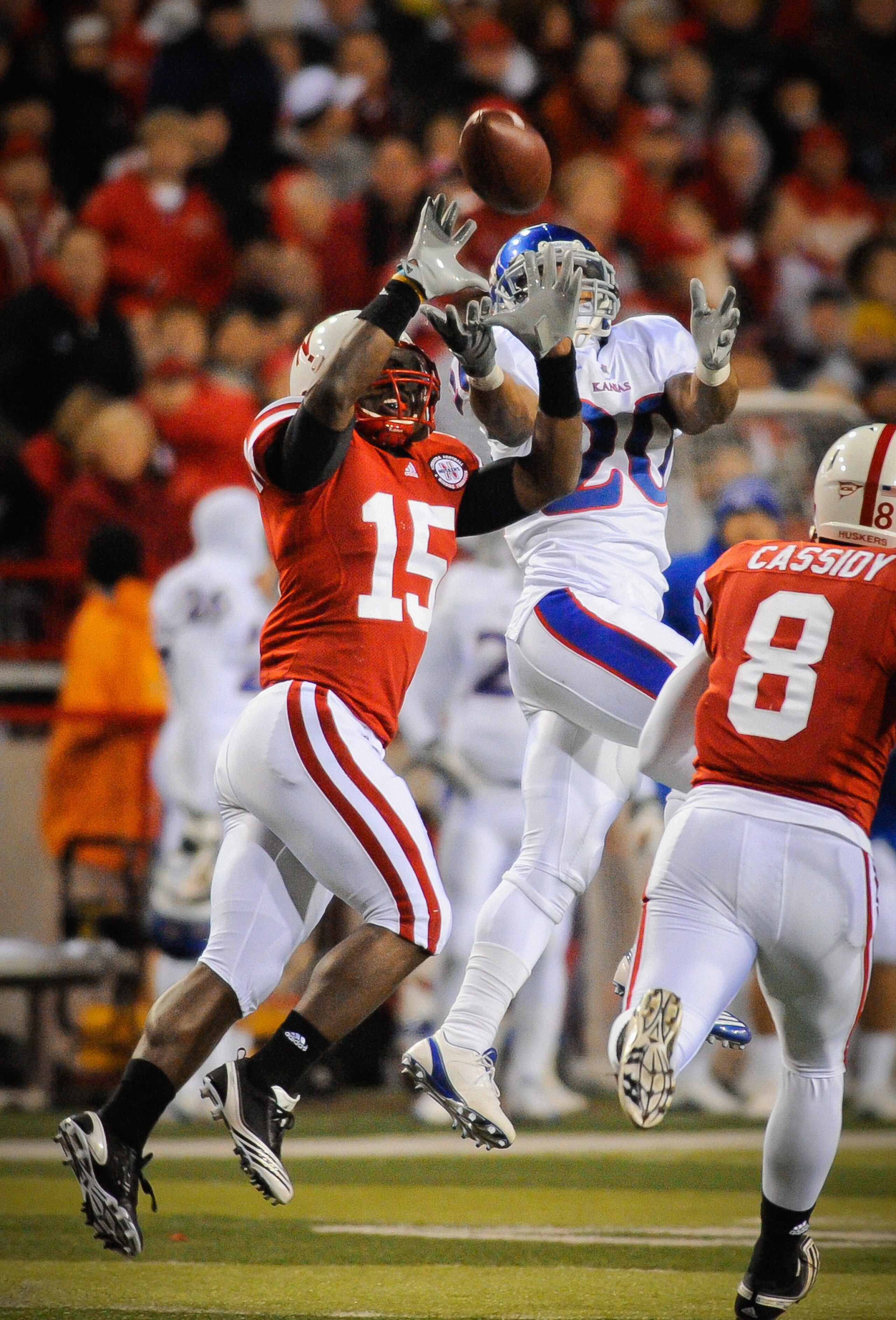 LINCOLN, NE - NOVEMBER 13: Alfonzo Dennard #15 of the Nebraska Cornhuskers takes the ball away from D.J. Beshears #20 of the Kansas Jayhawks during second half action of their game at Memorial Stadium on November 13, 2010 in Lincoln, Nebraska. Nebraska De