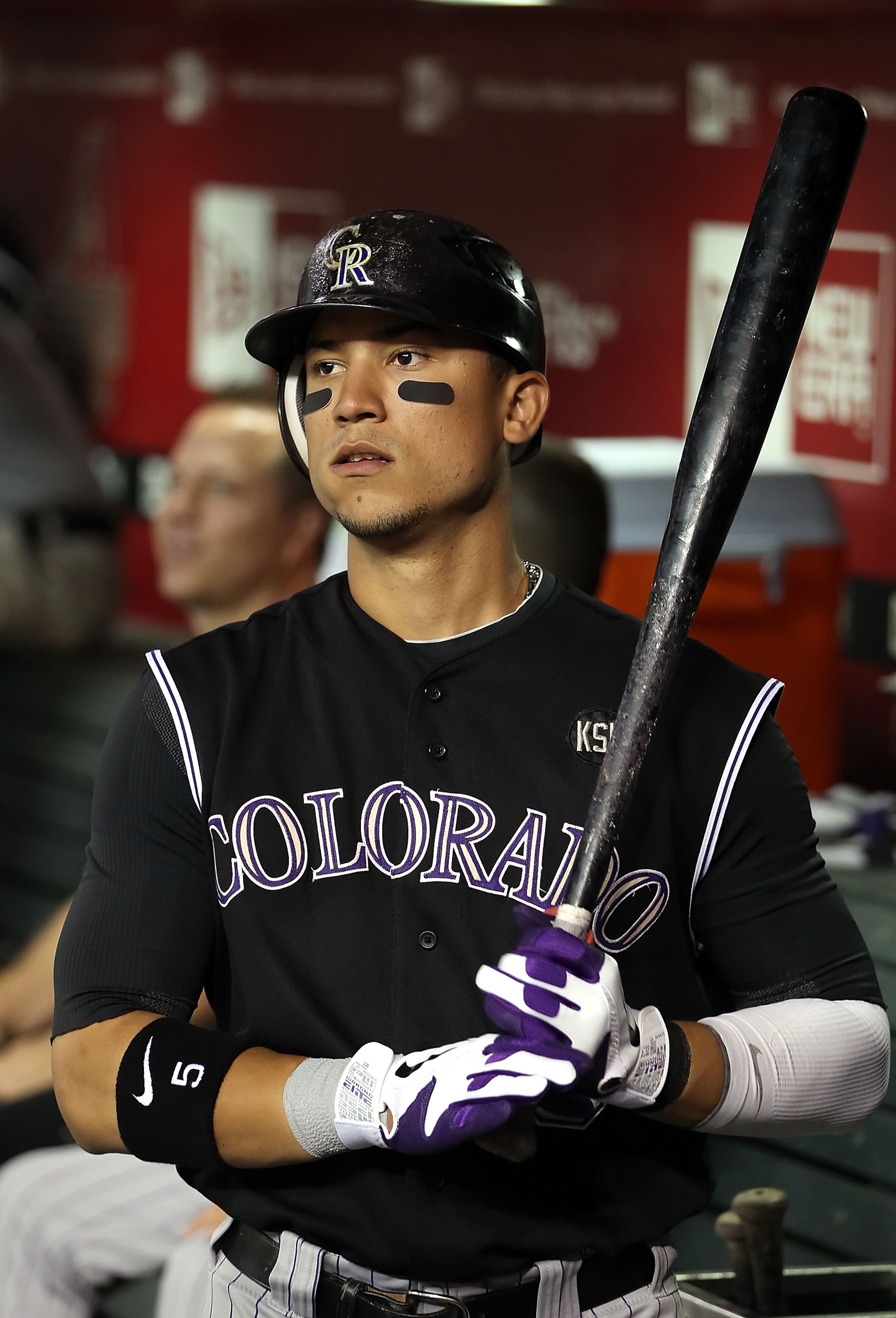PHOENIX - SEPTEMBER 21:  Carlos Gonzalez #5 of the Colorado Rockies looks on from the dugout during the Major League Baseball game against the Arizona Diamondbacks at Chase Field on September 21, 2010 in Phoenix, Arizona.  (Photo by Christian Petersen/Get