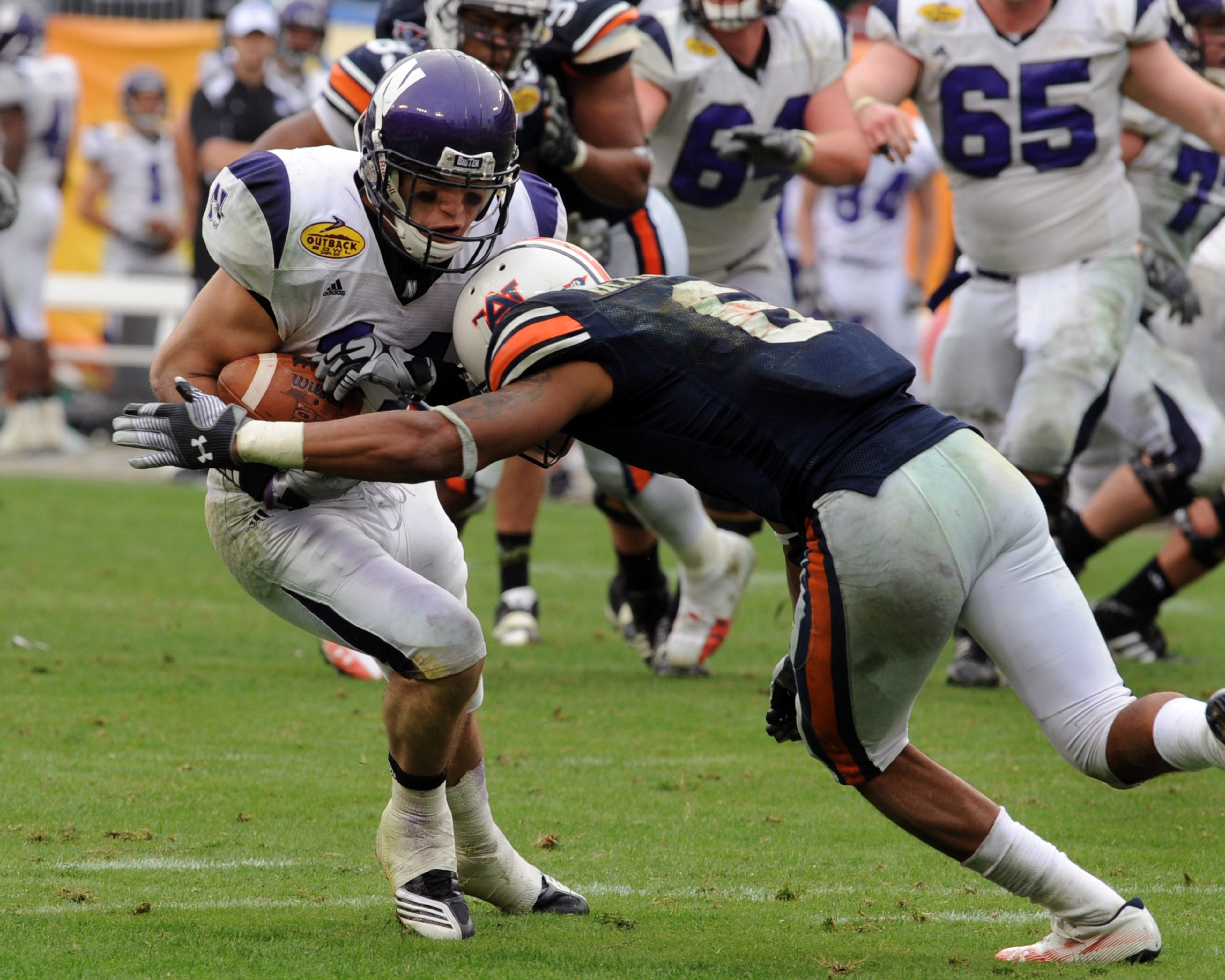 TAMPA, FL - JANUARY 1: Wide receiver Jeremy Ebert #11 of the Northwestern Wildcats grabs a pass against the Auburn Tigers in the Outback Bowl January 1, 2010 at Raymond James Stadium in Tampa, Florida. (Photo by Al Messerschmidt/Getty Images) TAMPA, FL - JANUARY 1: Wide receiver Jeremy Ebert #11 of the Northwestern Wildcats grabs a pass against the Auburn Tigers in the Outback Bowl January 1, 2010 at Raymond James Stadium in Tampa, Florida. (Photo by Al Messerschmidt/Getty Images)