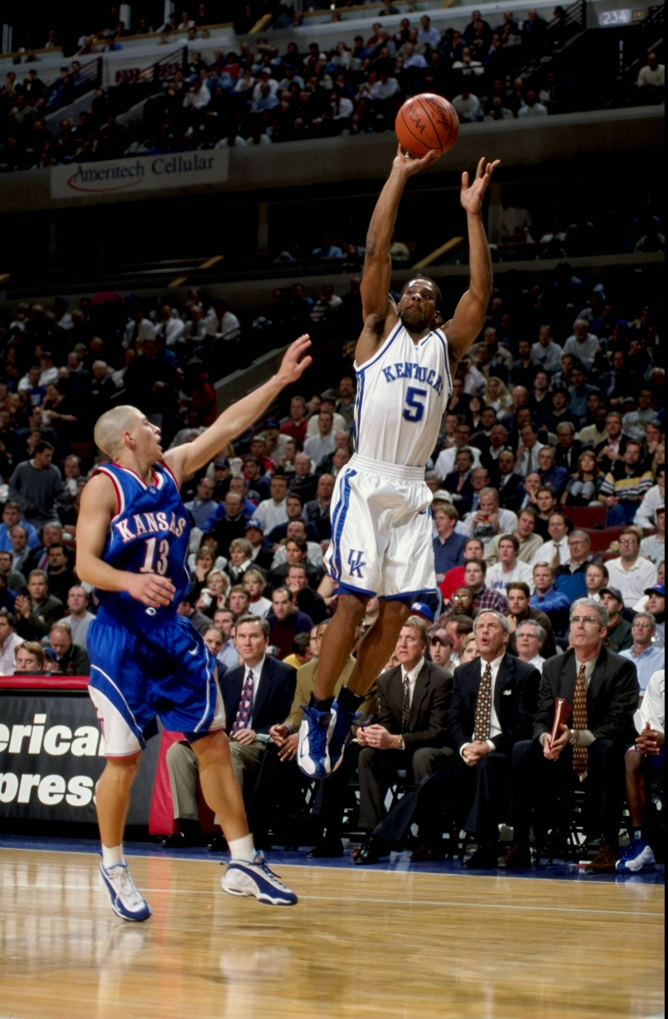 Wayne Turner #5 of the Kentucky Wildcats shoots as Jeff Boschee #13 of the Kansas Jayhawks blocks at the United Center in Chicago, Illinois. Kentucky defeated Kansas 63-45.