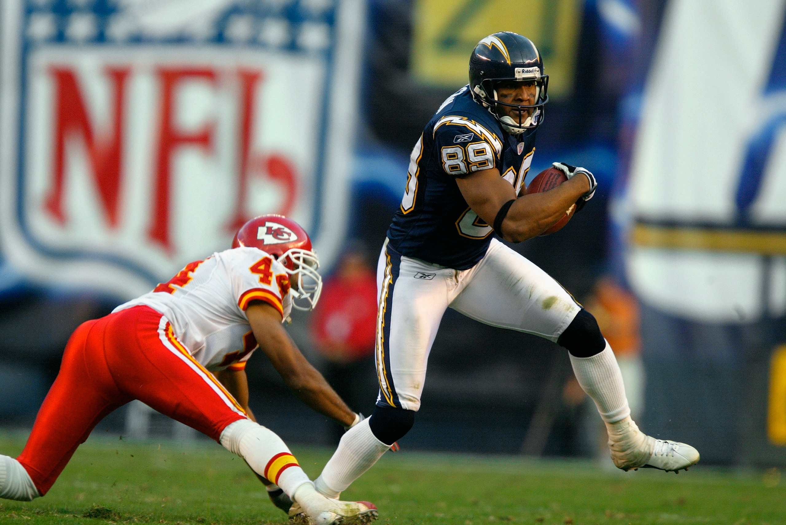 SAN DIEGO - NOVEMBER 30:  Wide receiver David Boston #89 of the San Diego Chargers carries the ball around cornerback Eric Warfield #42 of the Kansas City Chiefs during the game at Qualcomm Stadium on November 30, 2003 in San Diego, California. The Chiefs
