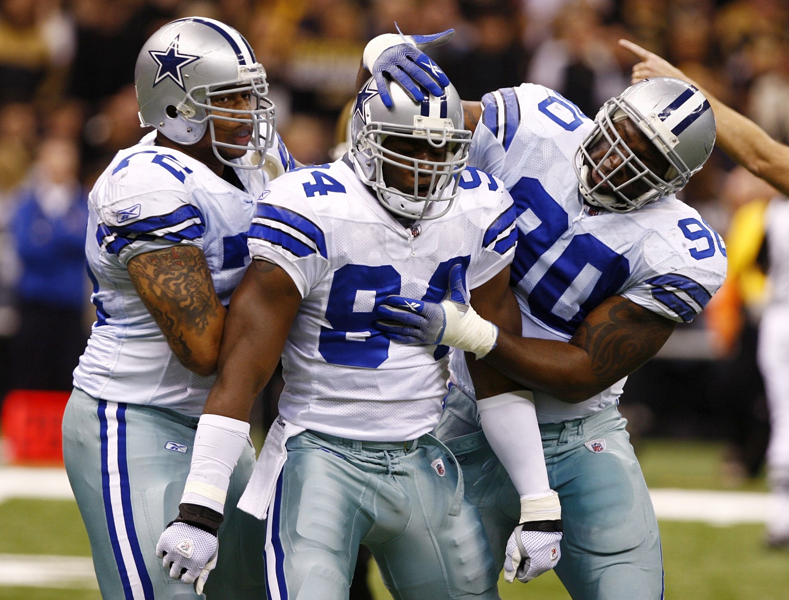 NEW ORLEANS - DECEMBER 19:  Linebacker DeMarcus Ware #94 of the Dallas Cowboys celebrates with defensive ends Jay Ratliff (R) #90 and Stephen Bowen (L) #72 after a sack against the New Orleans Saints at the Louisiana Superdome on December 19, 2009 in New