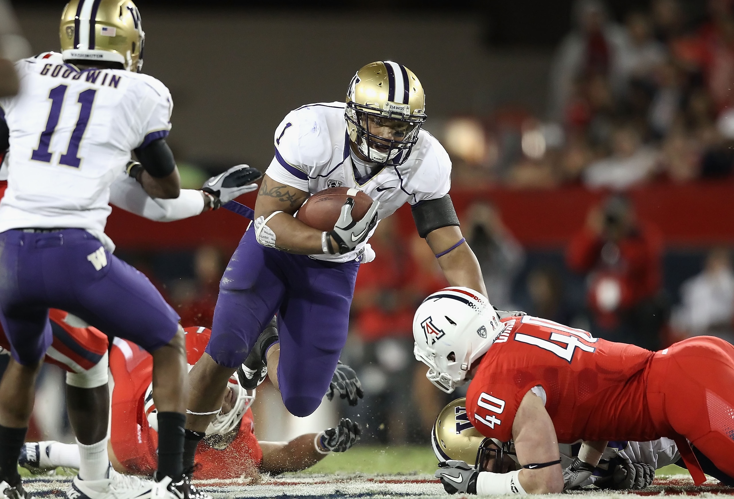 TUCSON, AZ - OCTOBER 23:  Runningback Chris Polk #1 of the Washington Huskies rushes the football during the college football game against the Arizona Wildcats at Arizona Stadium on October 23, 2010 in Tucson, Arizona. The Wildcats defeated the Huskies 44