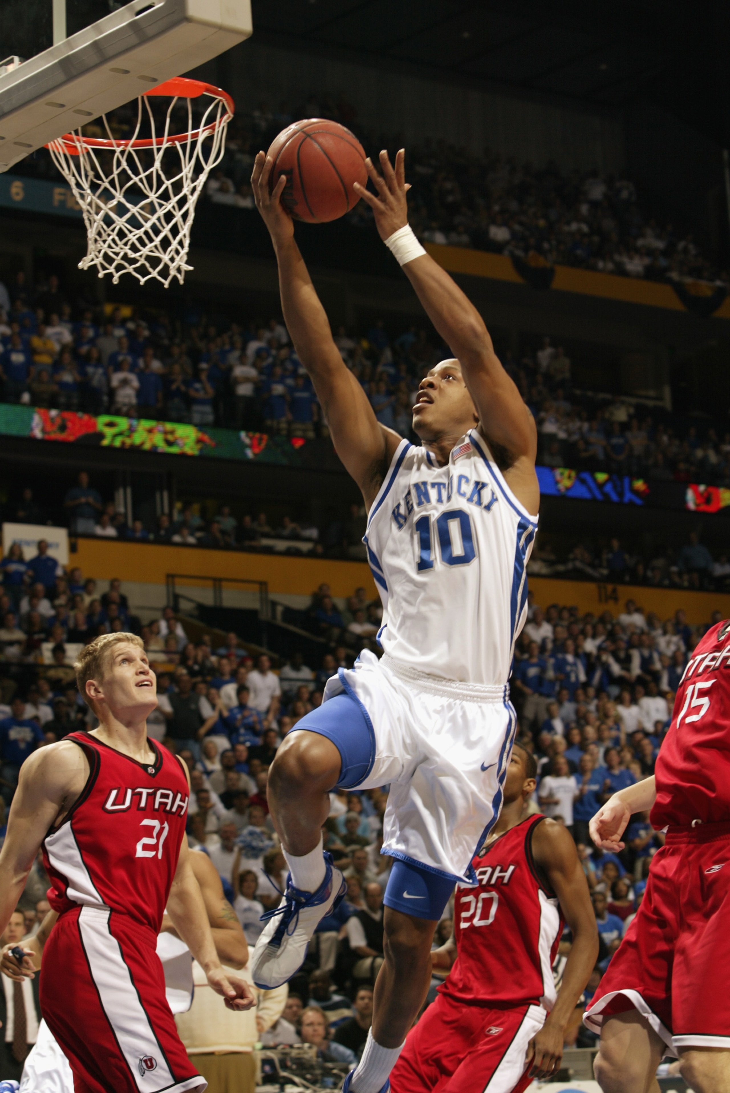 NASHVILLE, TN - MARCH 23:  Keith Bogans #10 of Kentucky drives to the net for two as Bryant Markson #20 and Trace Caton #21 of Utah look on during the second round of the NCAA Mens Basketball Championship on March 23, 2003 at the Gaylord Entertainment Cen