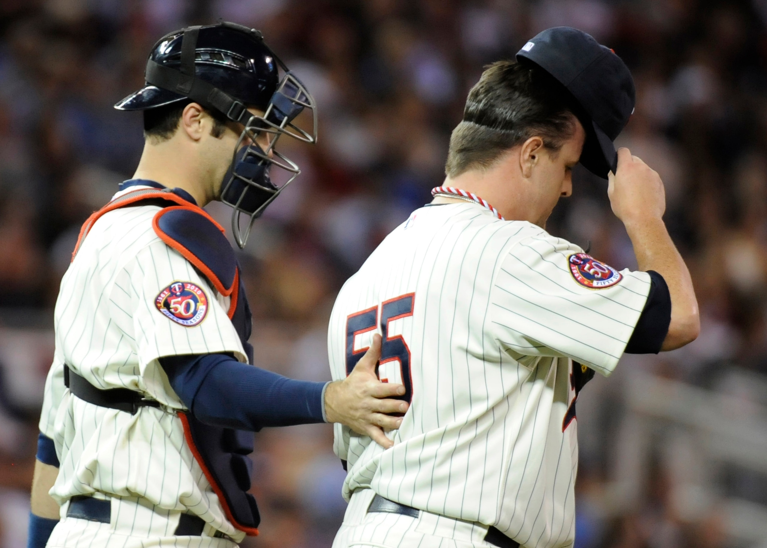 MINNEAPOLIS, MN - OCTOBER 7: Joe Mauer #7 and Matt Capps #55 of the Minnesota Twins speak on the mound in the ninth inning during game two of the ALDS game against the New York Yankees on October 7, 2010 at Target Field in Minneapolis, Minnesota. (Photo b
