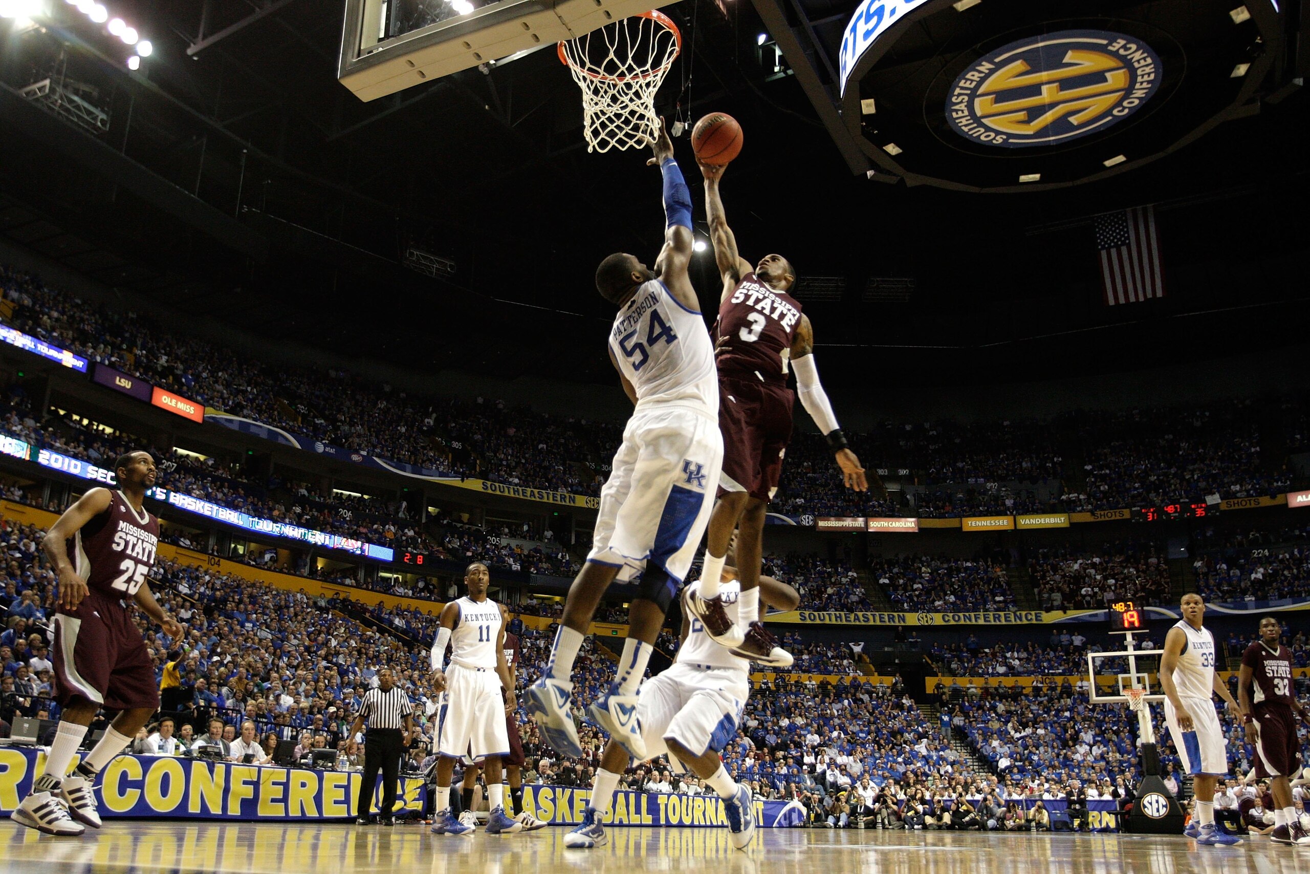 NASHVILLE, TN - MARCH 14:  Dee Bost #3 of the Mississippi State Bulldogs drives for a shot attempt against Patrick Patterson #54 of the Kentucky Wildcats during the final of the SEC Men's Basketball Tournament at the Bridgestone Arena on March 14, 2010 in