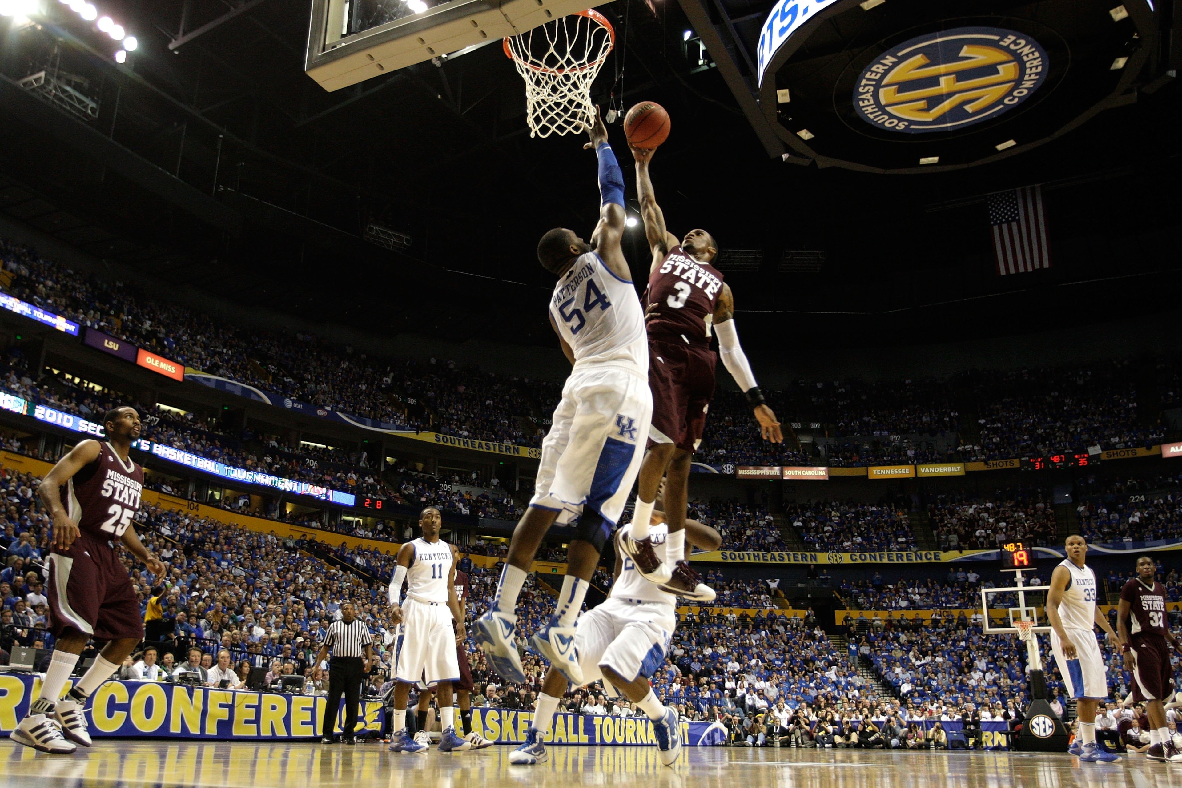 NASHVILLE, TN - MARCH 14:  Dee Bost #3 of the Mississippi State Bulldogs drives for a shot attempt against Patrick Patterson #54 of the Kentucky Wildcats during the final of the SEC Men's Basketball Tournament at the Bridgestone Arena on March 14, 2010 in