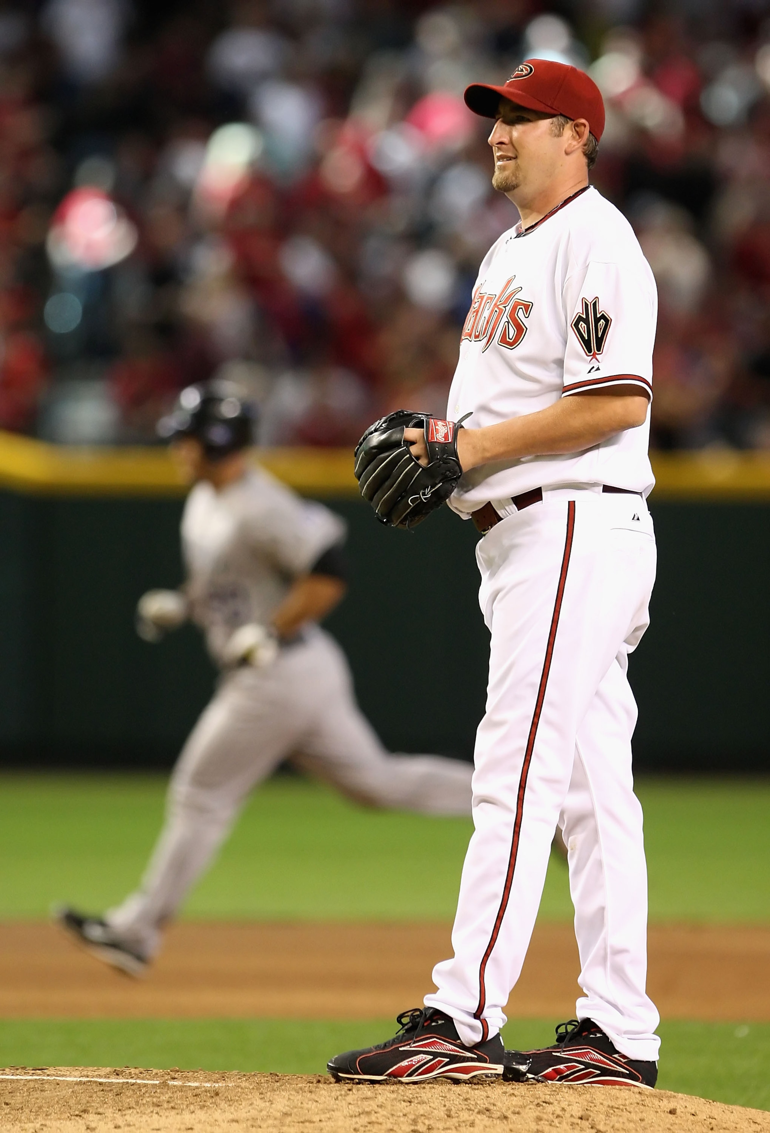 PHOENIX - APRIL 06:  Starting pitcher Brandon Webb #17 of the Arizona Diamondbacks reacts after giving up a solo home run to Chris Iannetta #20 of the Colorado Rockies during the MLB openning day game at Chase Field on April 6, 2009 in Phoenix, Arizona.