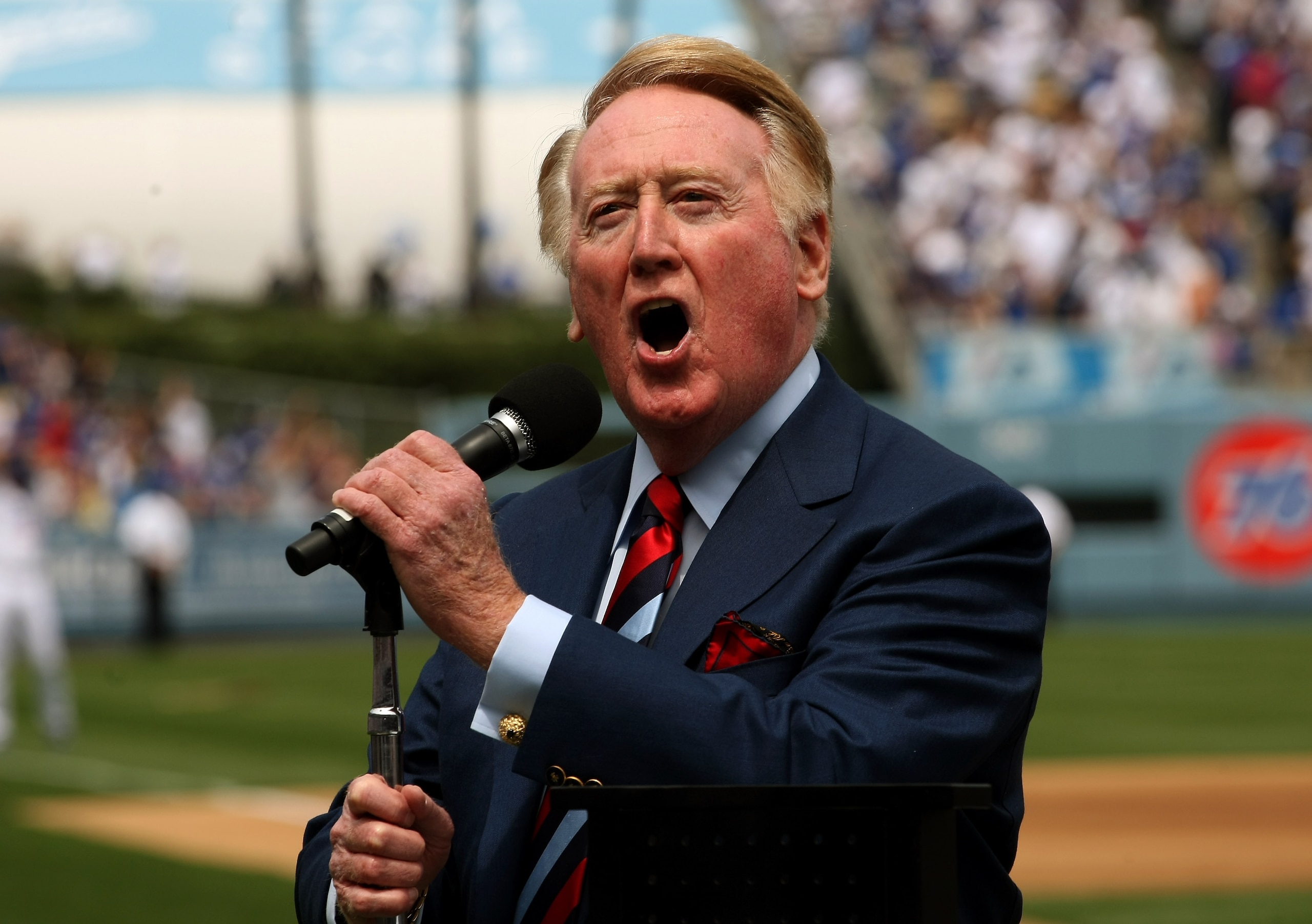 LOS ANGELES - APRIL 13:  Dodgers broadcaster Vin Scully gives the call of 'It's time for Dodger baseball!' during pregame ceremonies for the Los Angeles Dodgers home opener against the San Francisco Giants on April 13, 2009 at Dodger Stadiium in Los Angel