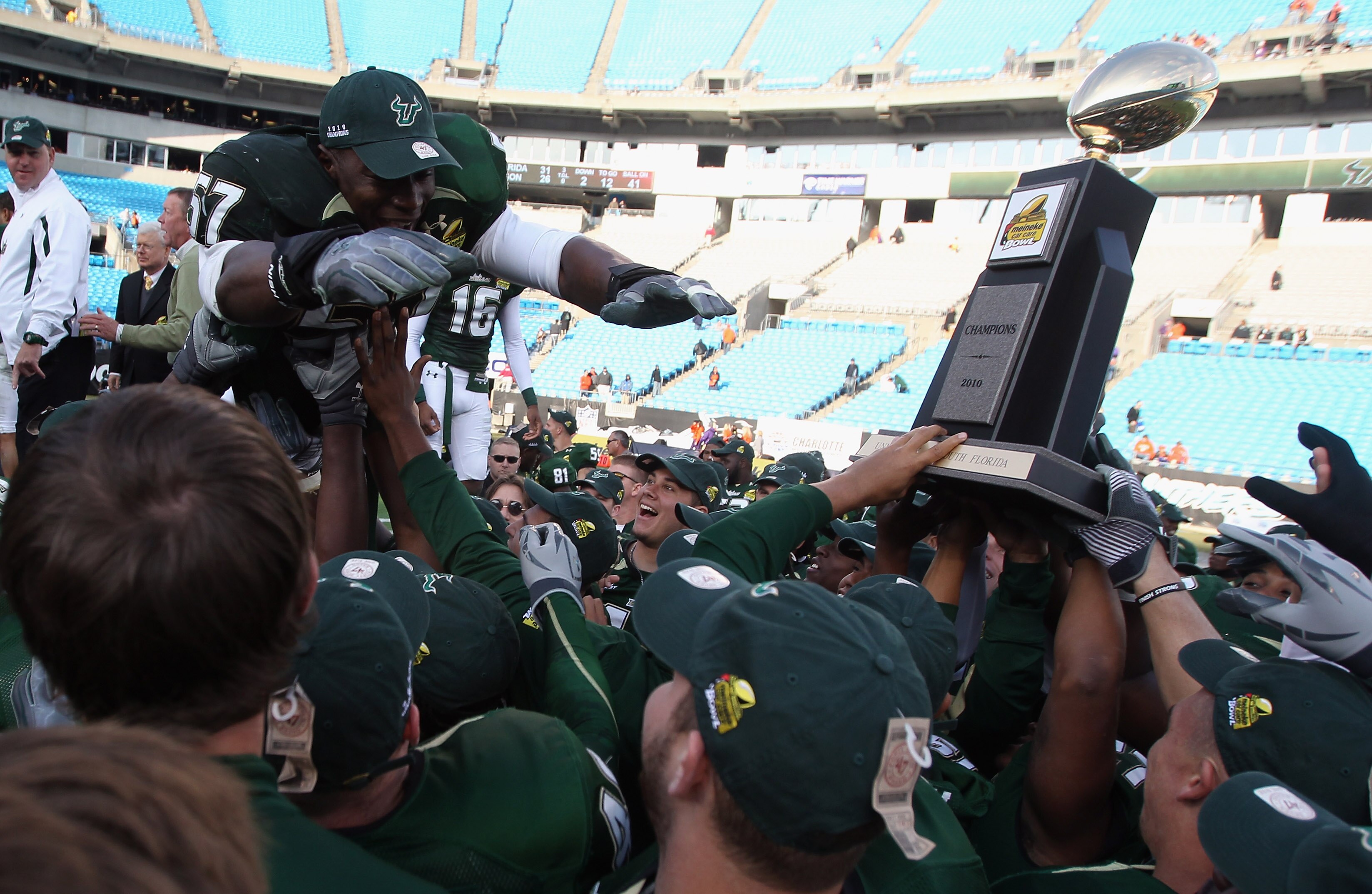 CHARLOTTE, NC - DECEMBER 31:  Jacquian Williams #57 of the USF Bulls jumps to his teammates after a 31-26 victory over the Clemson Tigers at Bank of America Stadium on December 31, 2010 in Charlotte, North Carolina.  (Photo by Streeter Lecka/Getty Images)