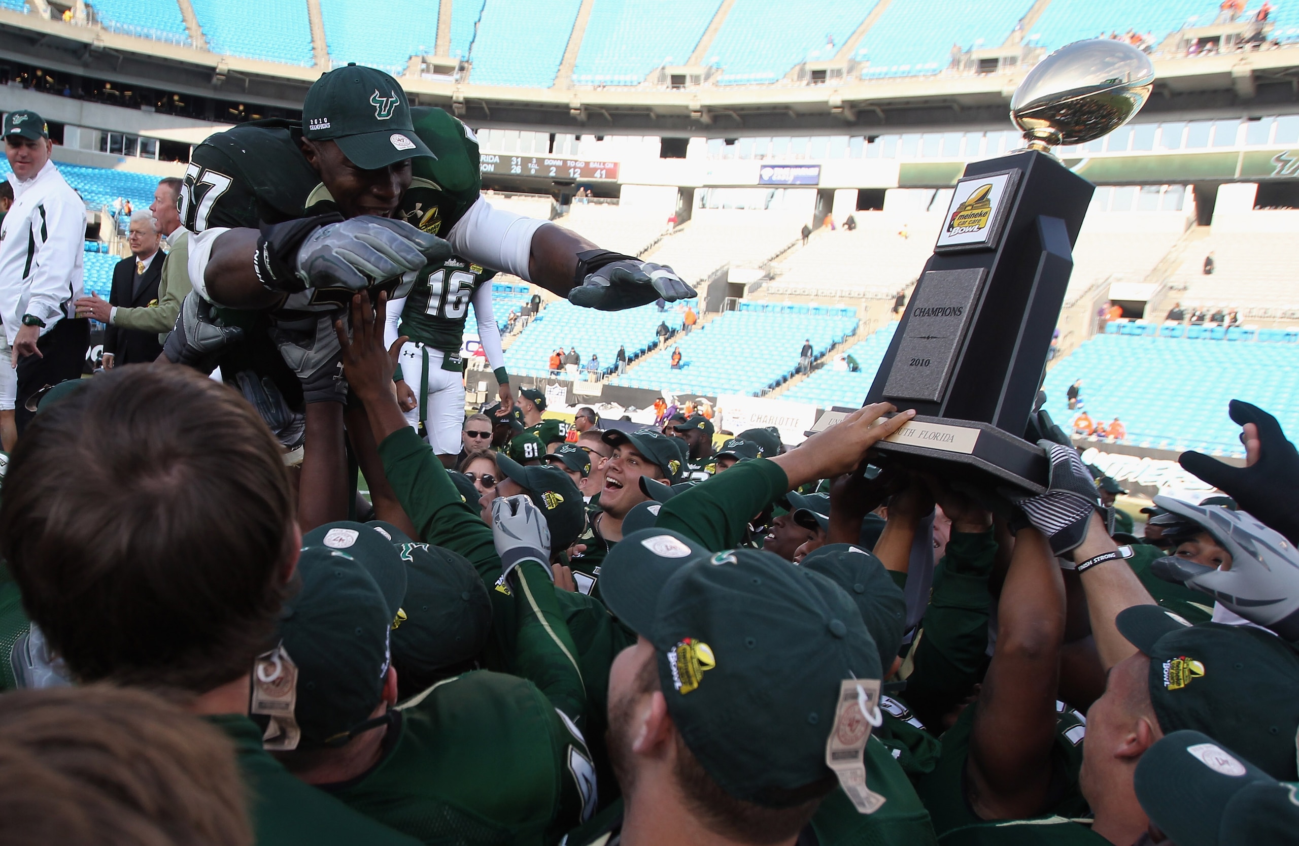 CHARLOTTE, NC - DECEMBER 31:  Jacquian Williams #57 of the USF Bulls jumps to his teammates after a 31-26 victory over the Clemson Tigers at Bank of America Stadium on December 31, 2010 in Charlotte, North Carolina.  (Photo by Streeter Lecka/Getty Images)