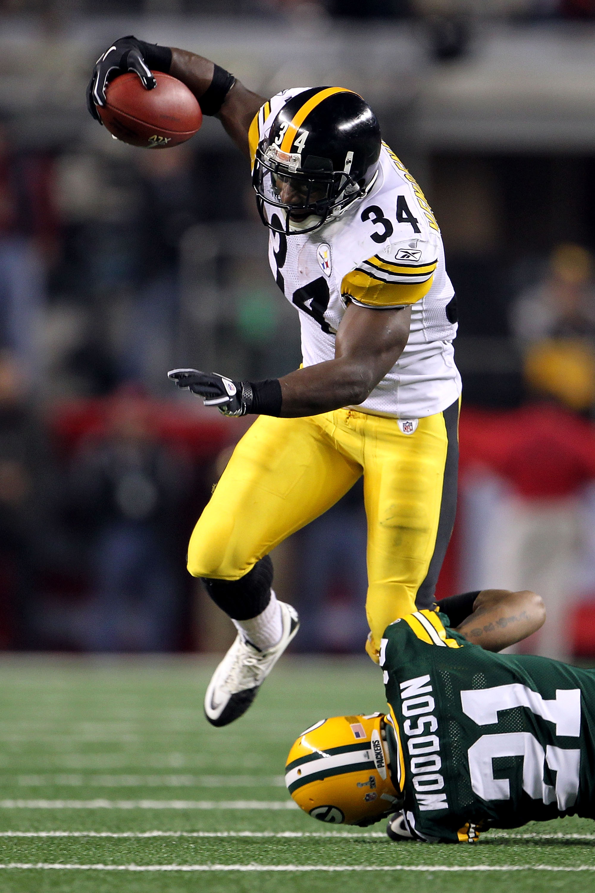 Pittsburgh Steelers runningback Rashard Mendenhall is tackled by Green Bay  Packers cornerback Charles Woodson in the first half during Super Bowl XLV  at Cowboys Stadium in Arlington, Texas on February 6, 2011.