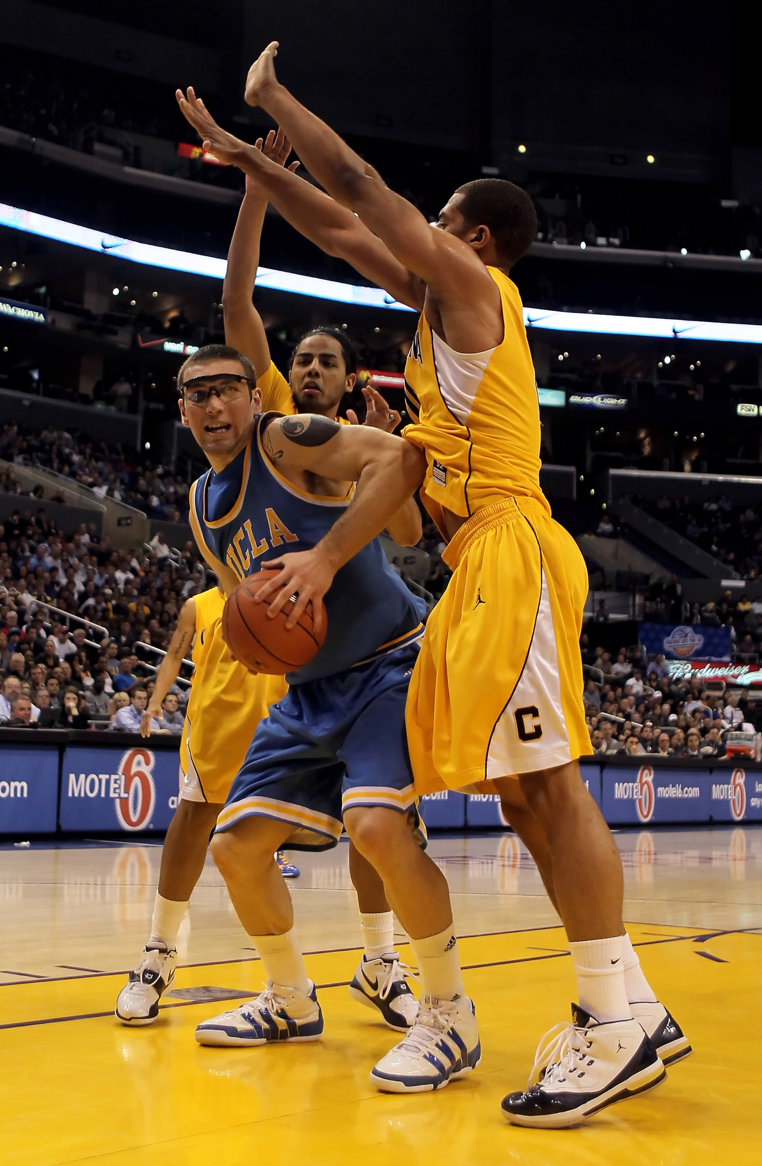 LOS ANGELES, CA - MARCH 12: Reeves Nelson #11 of the UCLA Bruins is defended by Jorge Gutierrez (L) #2 and Jamal Boykin (R) #10 of the Cal Golden Bears in the second half during the Semifinals of the Pac-10 Basketball Tournament at Staples Center on Marc LOS ANGELES, CA - MARCH 12: Reeves Nelson #11 of the UCLA Bruins is defended by Jorge Gutierrez (L) #2 and Jamal Boykin (R) #10 of the Cal Golden Bears in the second half during the Semifinals of the Pac-10 Basketball Tournament at Staples Center on Marc